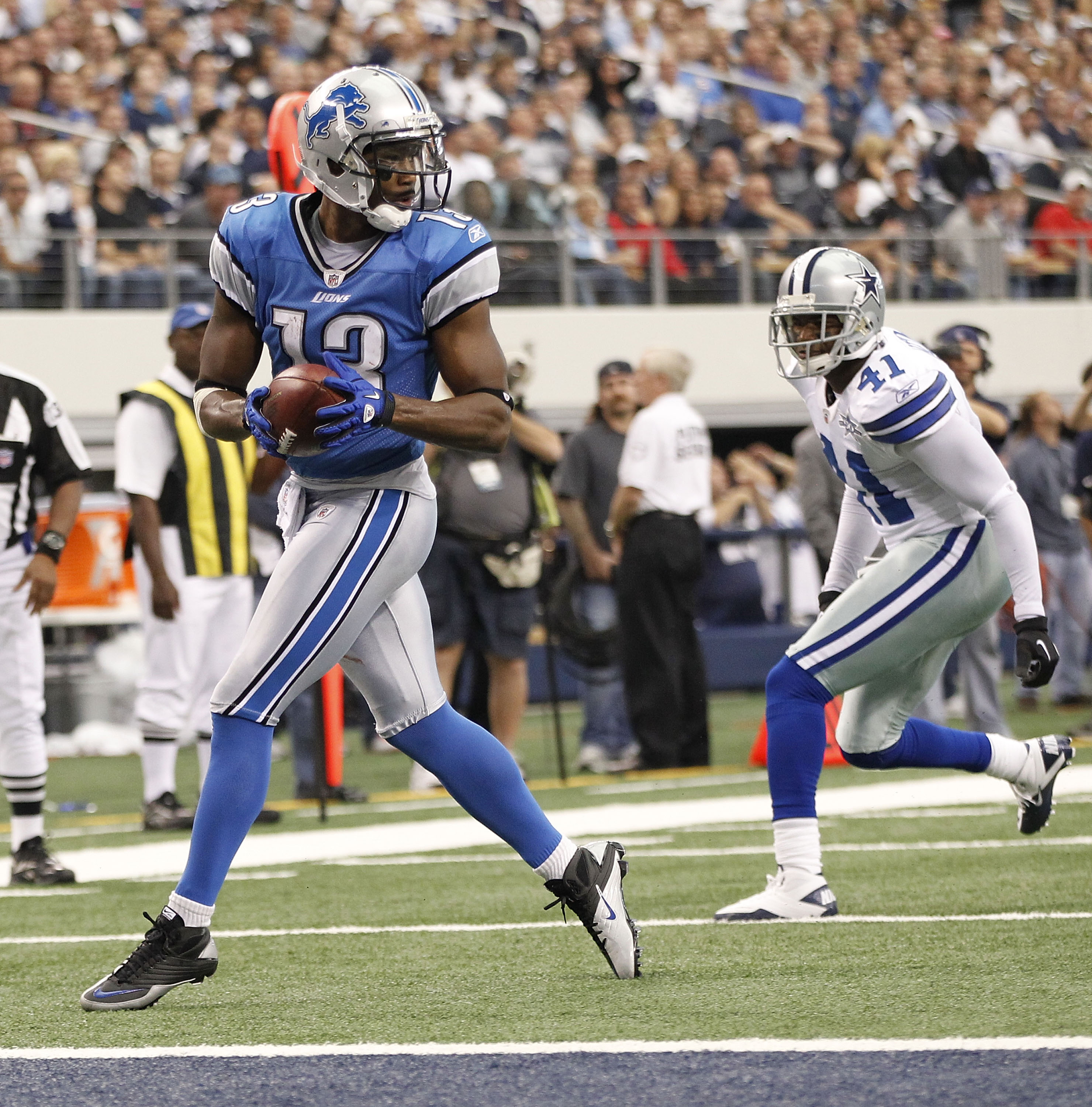 ARLINGTON, TX - NOVEMBER 21:  Nate Burleson #13 of the Detroit Lions scores a late second quarter touchdown as Terence Newman #41 of the Dallas Cowboys defends at Dallas Stadium on November 21, 2010 in Arlington, Texas.  (Photo by Leon Halip/Getty Images)