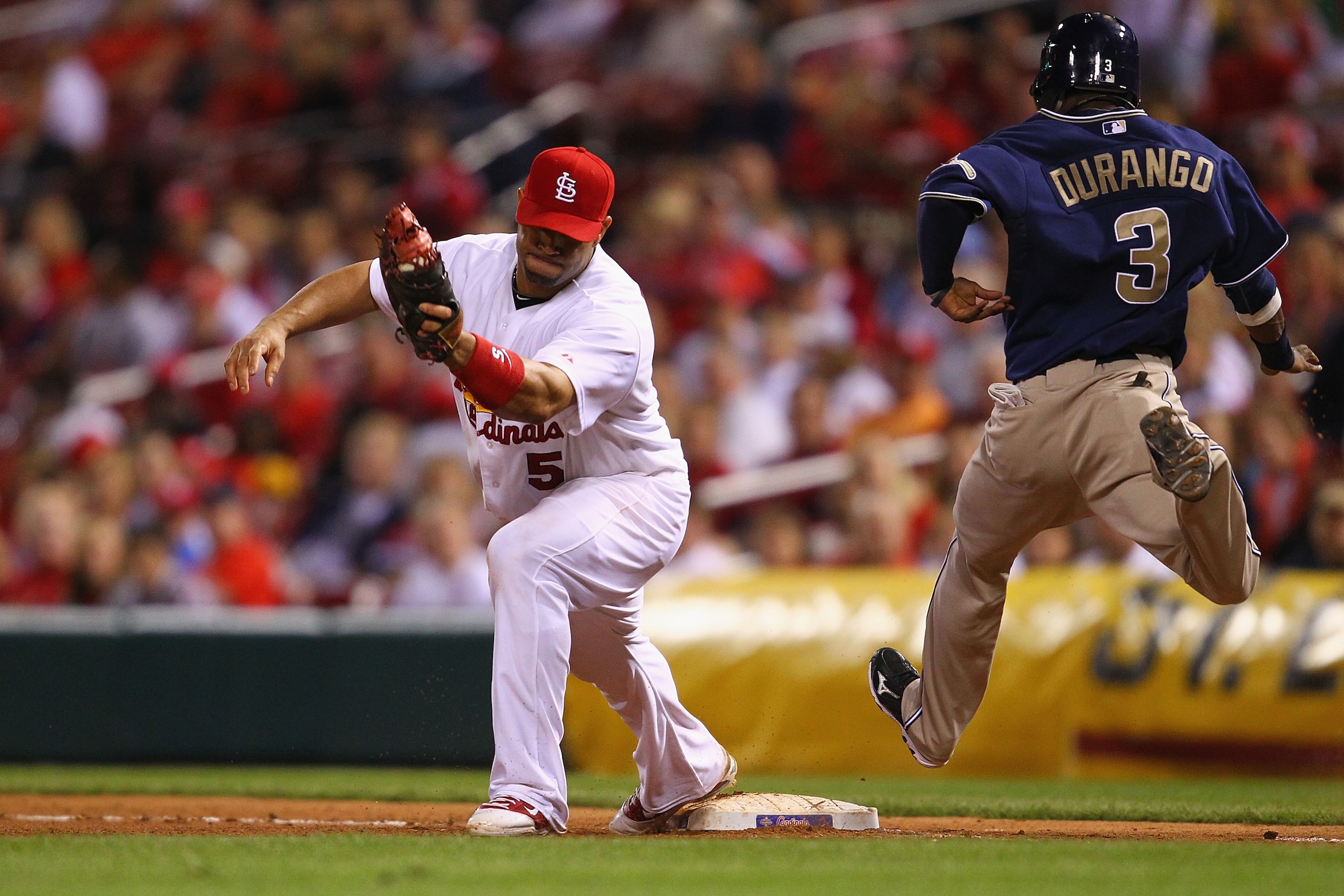 ST. LOUIS - SEPTEMBER 16: Albert Pujols #5 of the St. Louis Cardinals beats Luis Durango #3 of the San Diego Padres to first base for an out at Busch Stadium on September 16, 2010 in St. Louis, Missouri. (Photo by Dilip Vishwanat/Getty Images) ST. LOUIS - SEPTEMBER 16: Albert Pujols #5 of the St. Louis Cardinals beats Luis Durango #3 of the San Diego Padres to first base for an out at Busch Stadium on September 16, 2010 in St. Louis, Missouri. (Photo by Dilip Vishwanat/Getty Images)