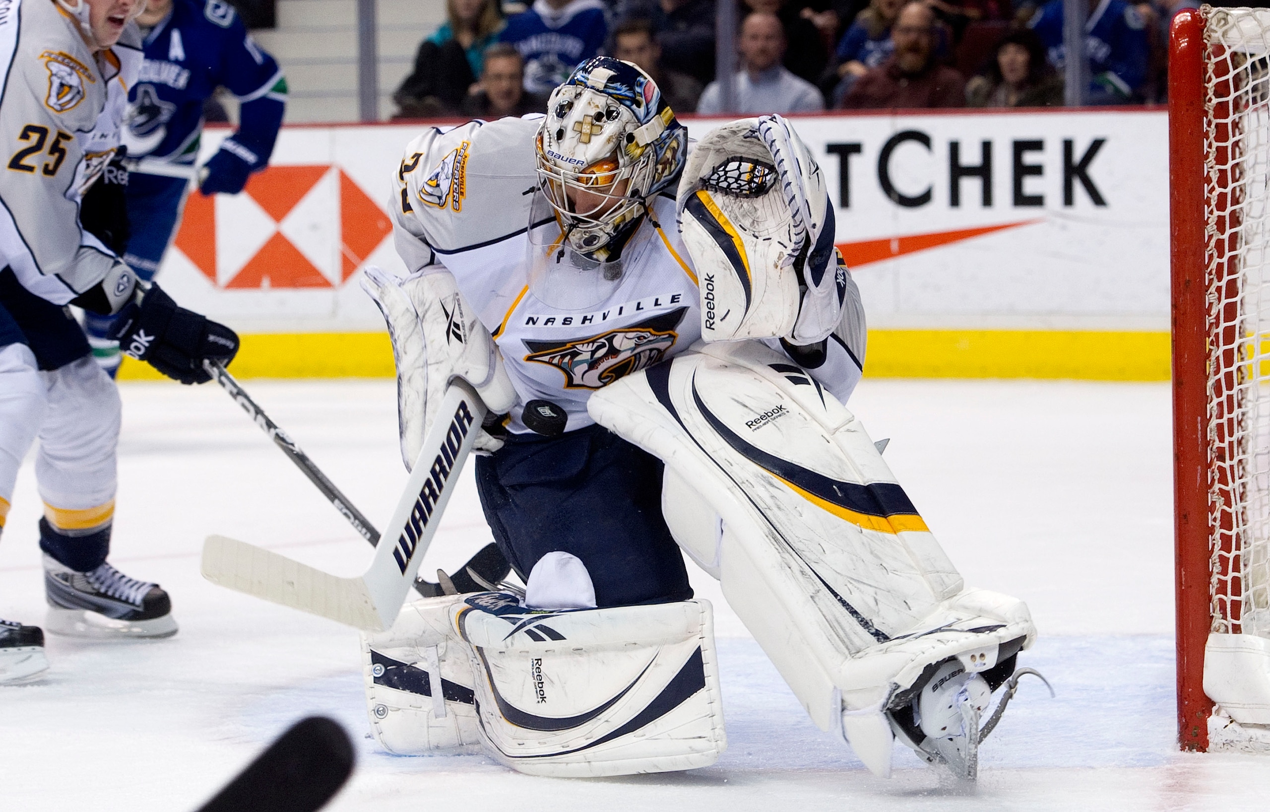 VANCOUVER, CANADA - JANUARY 26: Goalie Pekka Rinne #35 of the Nashville Predators slides across his crease to make a save against the Vancouver Canucks during the second period in NHL action on January 26, 2011 at Rogers Arena in Vancouver, British Columb VANCOUVER, CANADA - JANUARY 26: Goalie Pekka Rinne #35 of the Nashville Predators slides across his crease to make a save against the Vancouver Canucks during the second period in NHL action on January 26, 2011 at Rogers Arena in Vancouver, British Columb