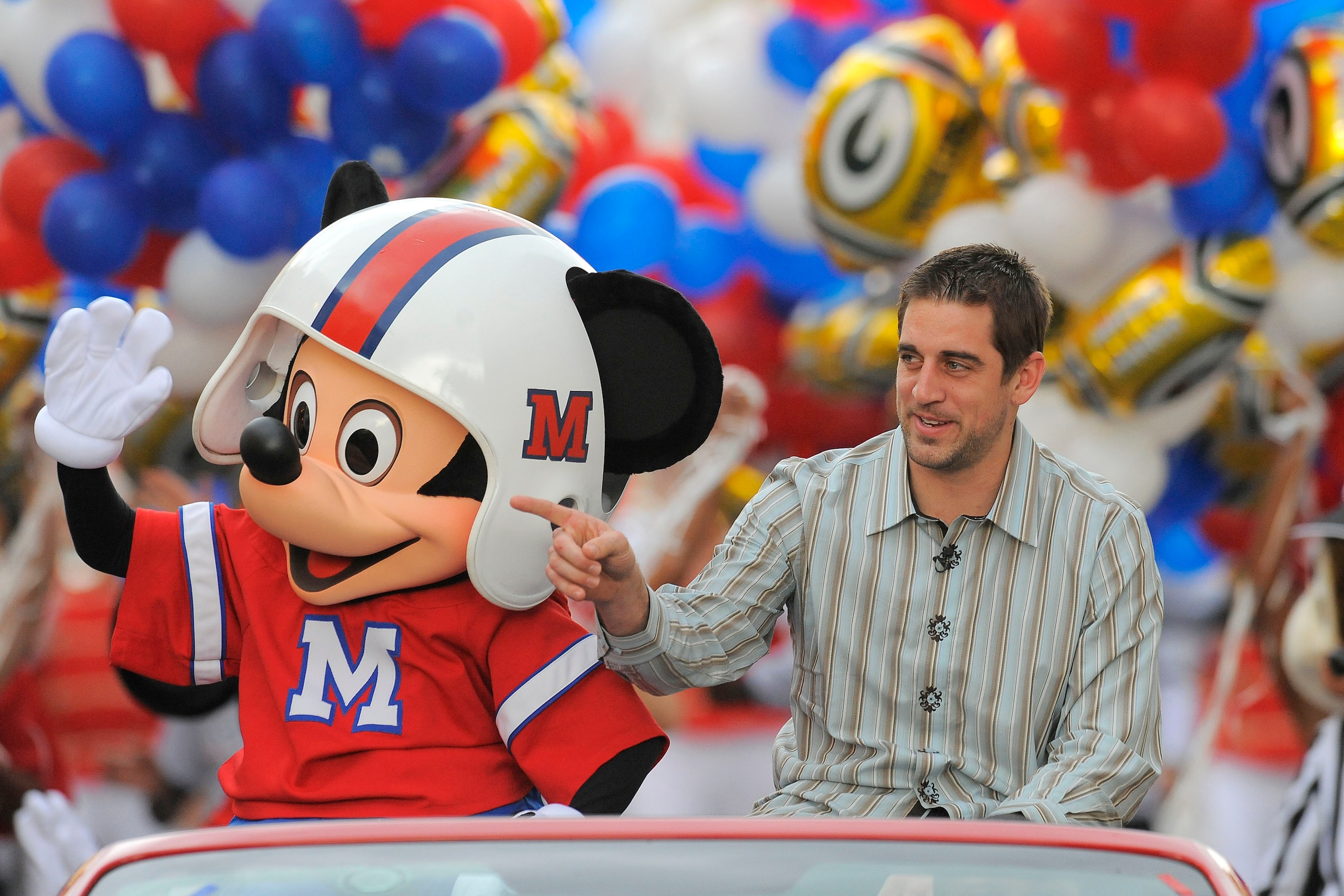 LAKE BUENA VISTA, FL - FEBRUARY 07:  In this handout photo provided by Disney, Super Bowl XLV Most Valuable Player Aaron Rodgers takes a celebratory ride with Mickey Mouse, following the Green Bay Packers' 31-25 victory over the Pittsburgh Steelers Februa