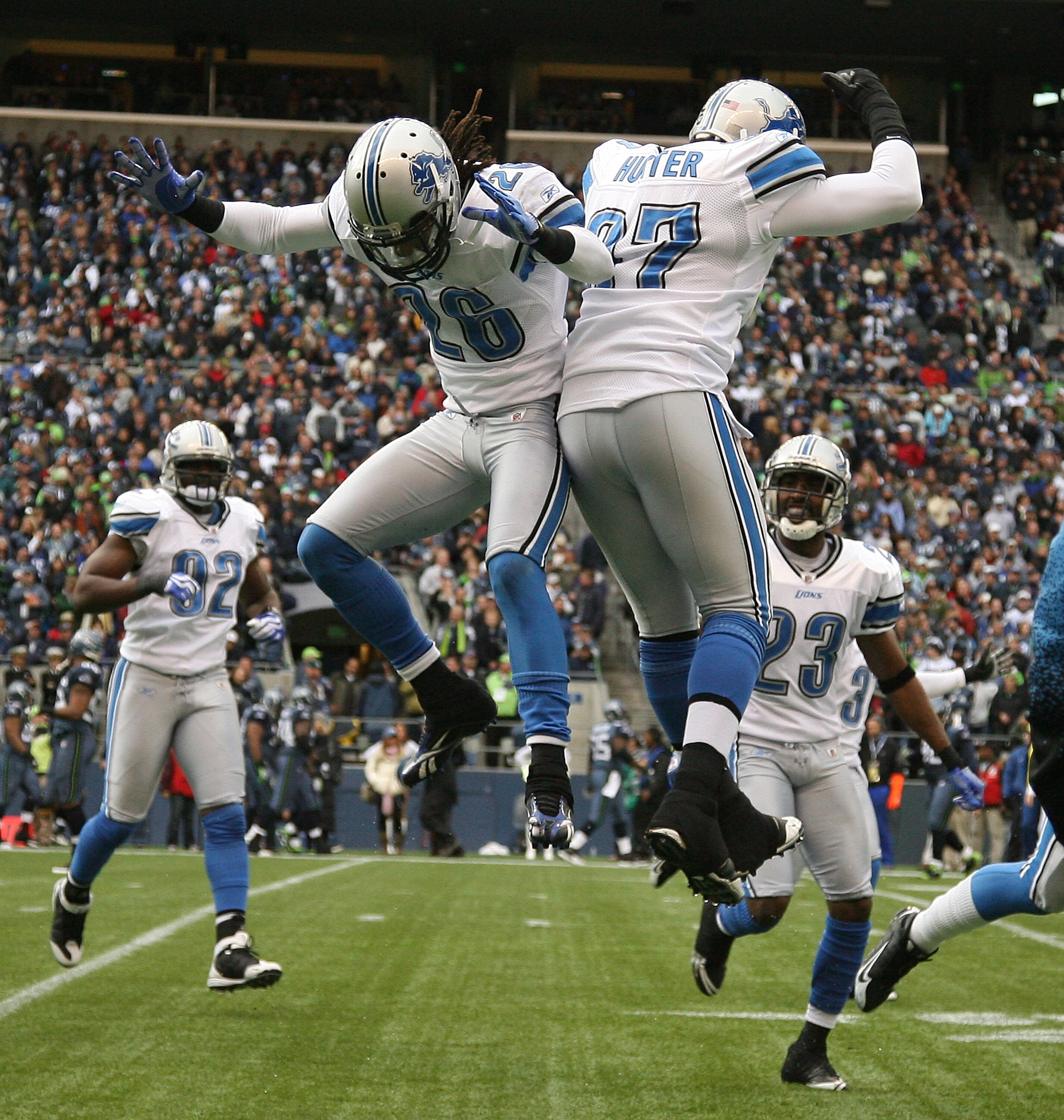 SEATTLE - NOVEMBER 08:  Safety Louis Delmas #26 of the Detroit Lions celebrates with Jason Hunter #97 after making an interception against the Seattle Seahawks on November 8, 2009 at Qwest Field in Seattle, Washington. (Photo by Otto Greule Jr/Getty Image