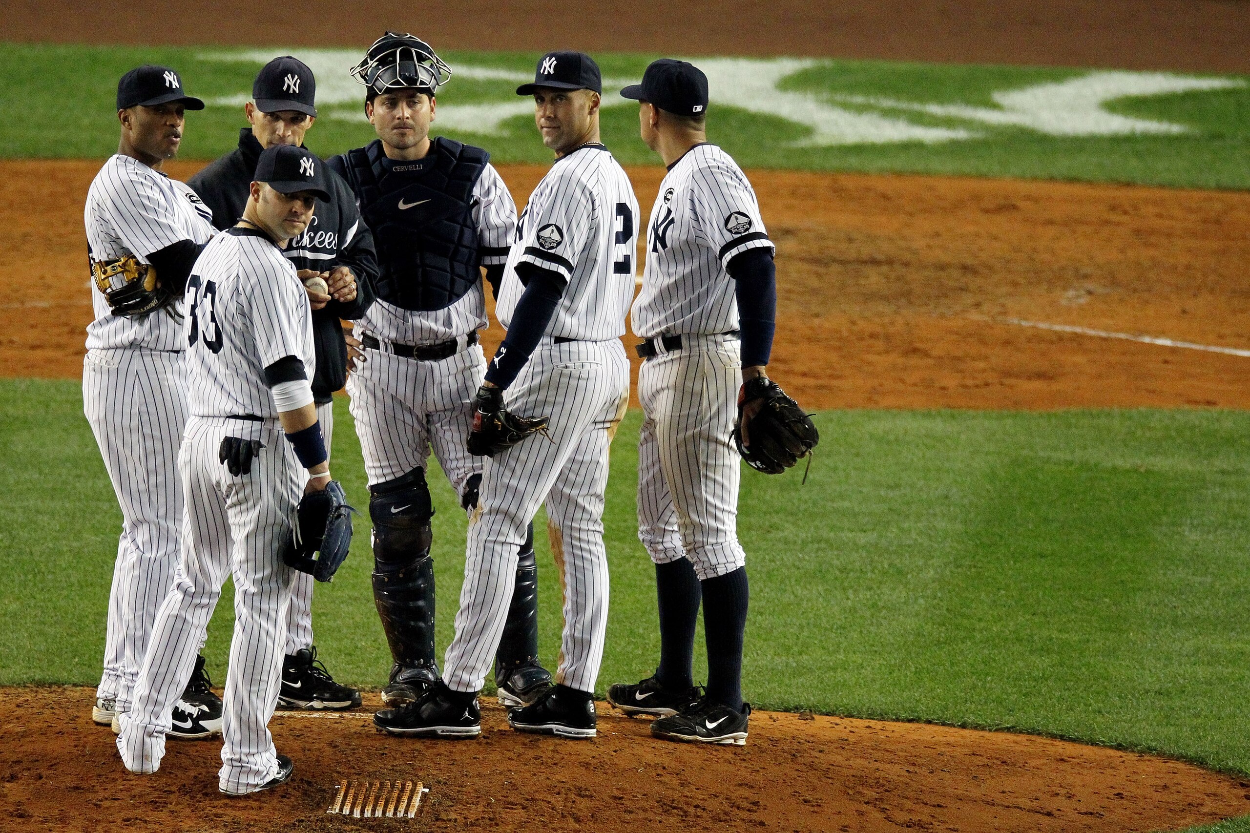 NEW YORK - OCTOBER 19: Manager Joe Girardi, Nick Swisher #33, Robinson Cano #24, Derek Jeter #2 and Alex Rodriguez #13 of the New York Yankees stand on the mound during a pitching change against the Texas Rangers in Game Four of the ALCS during the 2010 NEW YORK - OCTOBER 19: Manager Joe Girardi, Nick Swisher #33, Robinson Cano #24, Derek Jeter #2 and Alex Rodriguez #13 of the New York Yankees stand on the mound during a pitching change against the Texas Rangers in Game Four of the ALCS during the 2010