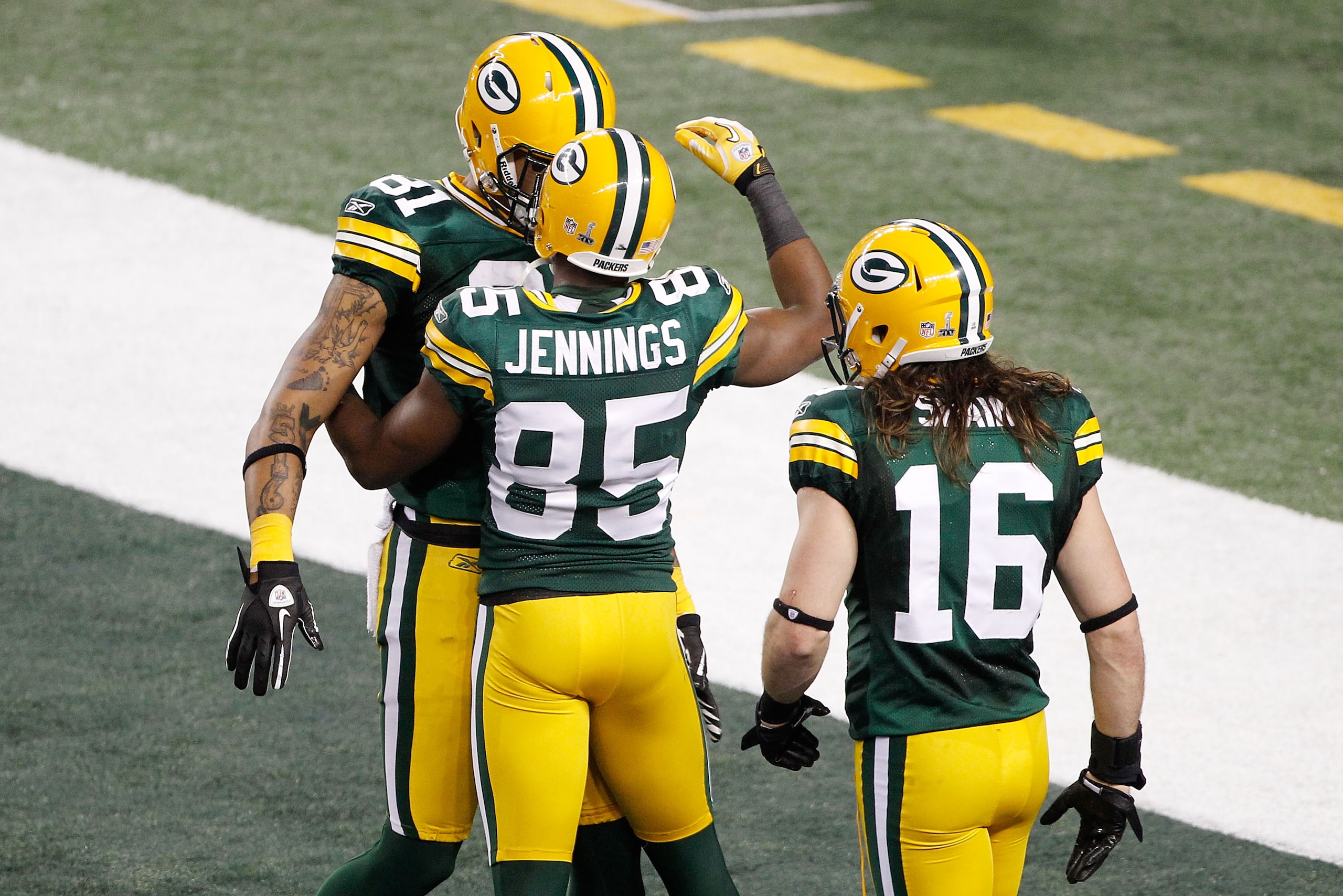 ARLINGTON, TX - FEBRUARY 06:  Greg Jennings #85 of the Green Bay Packers celebrates a fourth quarter touchdown against the Pittsburgh Steelers with teammates Andrew Quarless #81 and Brett Swain #16 during Super Bowl XLV at Cowboys Stadium on February 6, 2