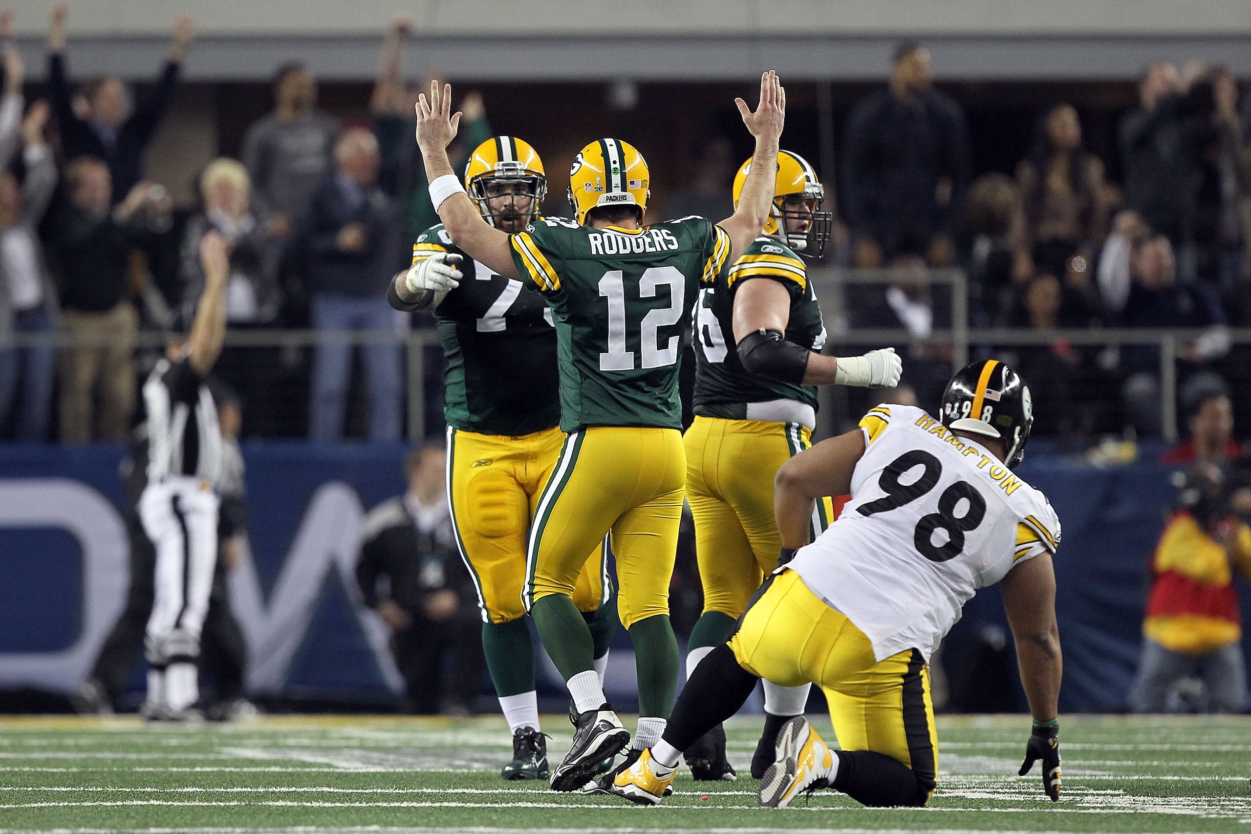 ARLINGTON, TX - FEBRUARY 06: Aaron Rodgers #12 of the Green Bay Packers celebrates late in the game against the Pittsburgh Steelers during Super Bowl XLV at Cowboys Stadium on February 6, 2011 in Arlington, Texas.  (Photo by Al Bello/Getty Images)