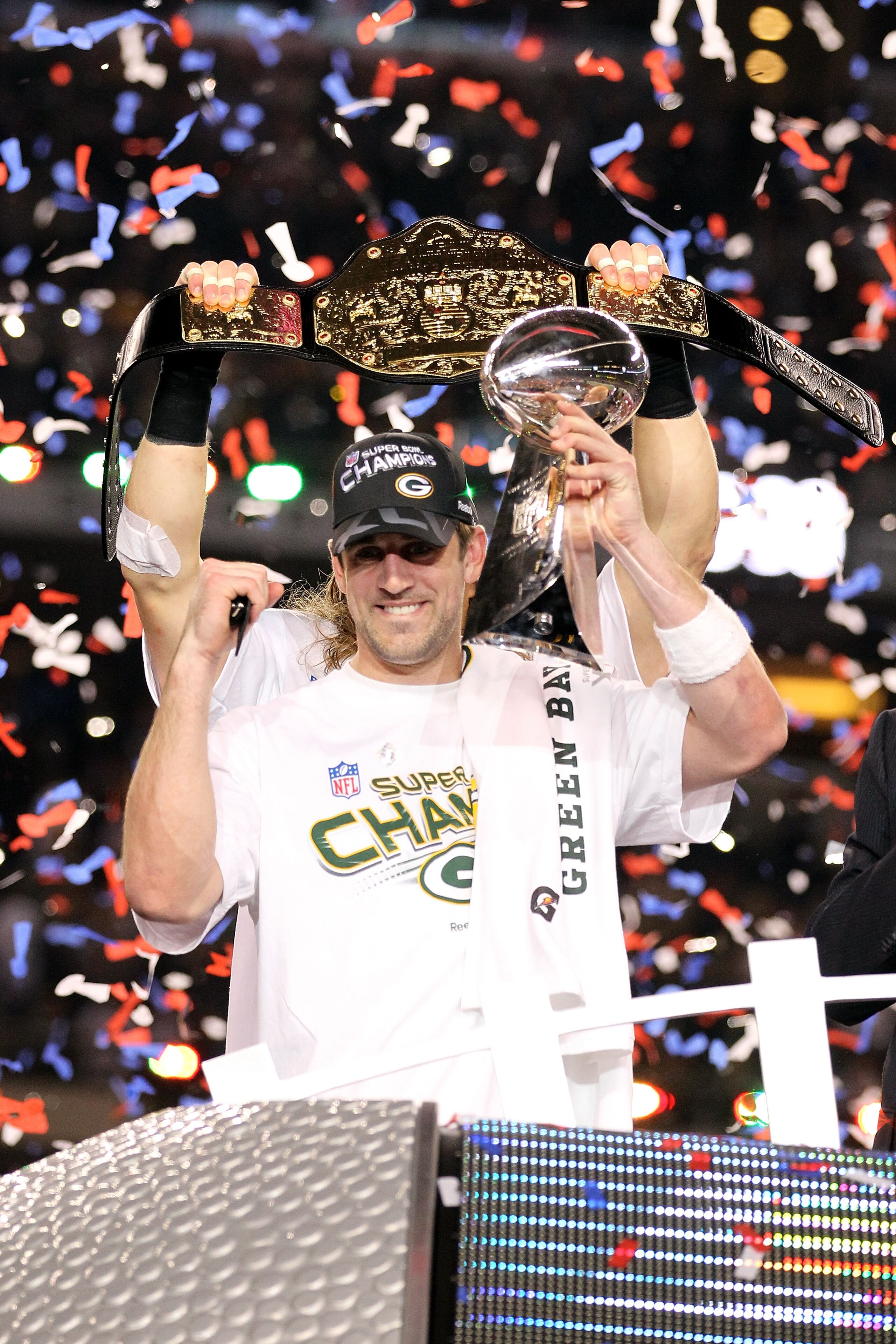 ARLINGTON, TX - FEBRUARY 06: Super Bowl MVP Aaron Rodgers #12 of the Green Bay Packers holds up the Vince Lombardi Trophy as Clay Matthews #52 holds up a championship belt after winning Super Bowl XLV 31-25 against the Pittsburgh Steelers at Cowboys Stadi