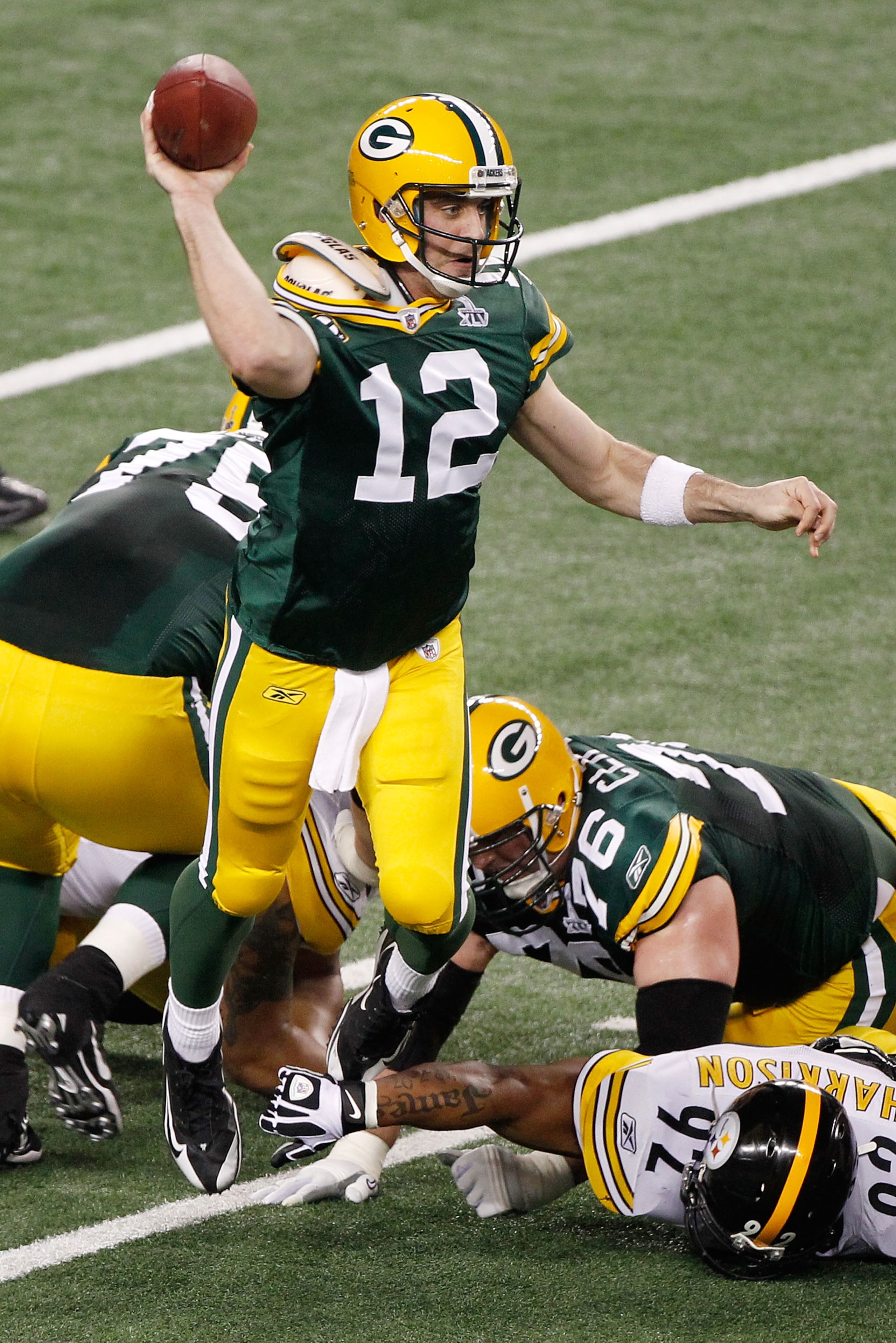 ARLINGTON, TX - FEBRUARY 06:  Aaron Rodgers #12 of the Green Bay Packers drops back against the Pittsburgh Steelers in the second quarter of Super Bowl XLV at Cowboys Stadium on February 6, 2011 in Arlington, Texas.  (Photo by Joe Robbins/Getty Images)