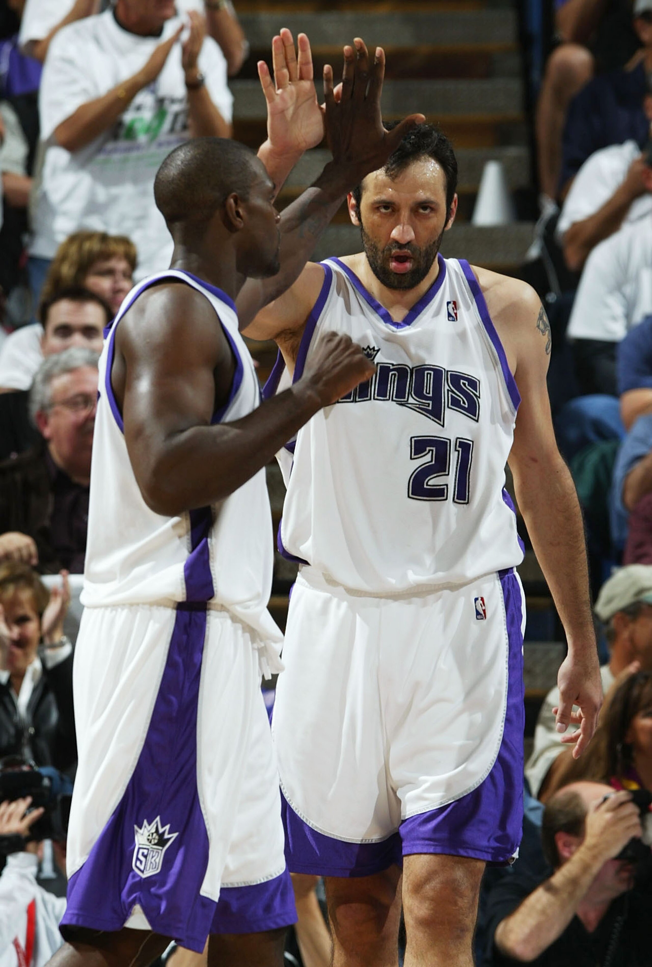 SACRAMENTO, CA - APRIL18: Chris Webber #4 and Vlade Divac #21 of the Sacramento Kings celebrate after scoring against the Dallas Mavericks during game 1 of the Western Conference First Round of the NBA Playoffs at Arco Arena on April 18, 2004 in Sacrame SACRAMENTO, CA - APRIL18: Chris Webber #4 and Vlade Divac #21 of the Sacramento Kings celebrate after scoring against the Dallas Mavericks during game 1 of the Western Conference First Round of the NBA Playoffs at Arco Arena on April 18, 2004 in Sacrame