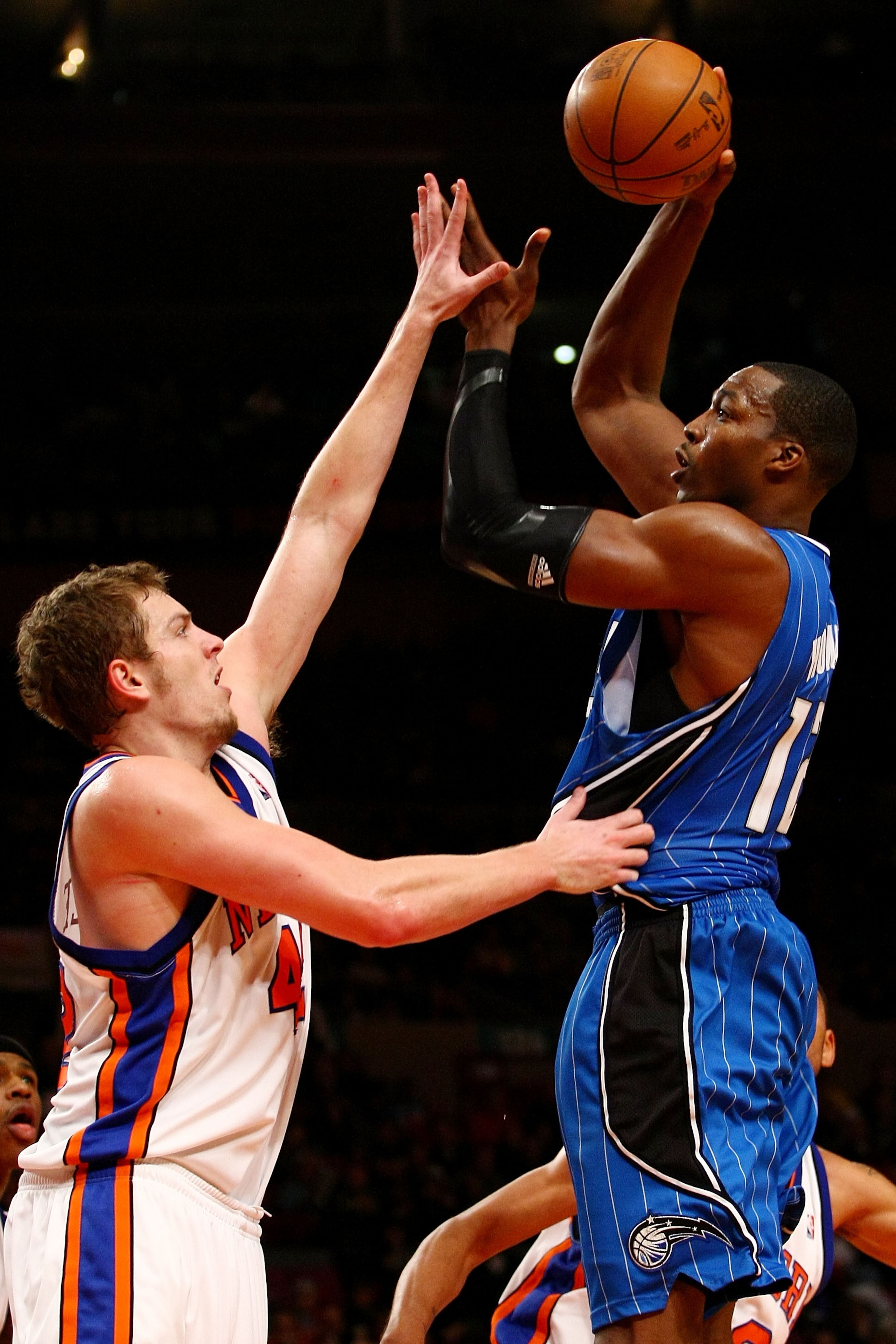 NEW YORK - NOVEMBER 29:  Dwight Howard #12 of the Orlando Magic shoots over David Lee #42 of the New York Knicks at Madison Square Garden November 29, 2009 in New York City. NOTE TO USER: User expressly acknowledges and agrees that, by downloading and/or 
