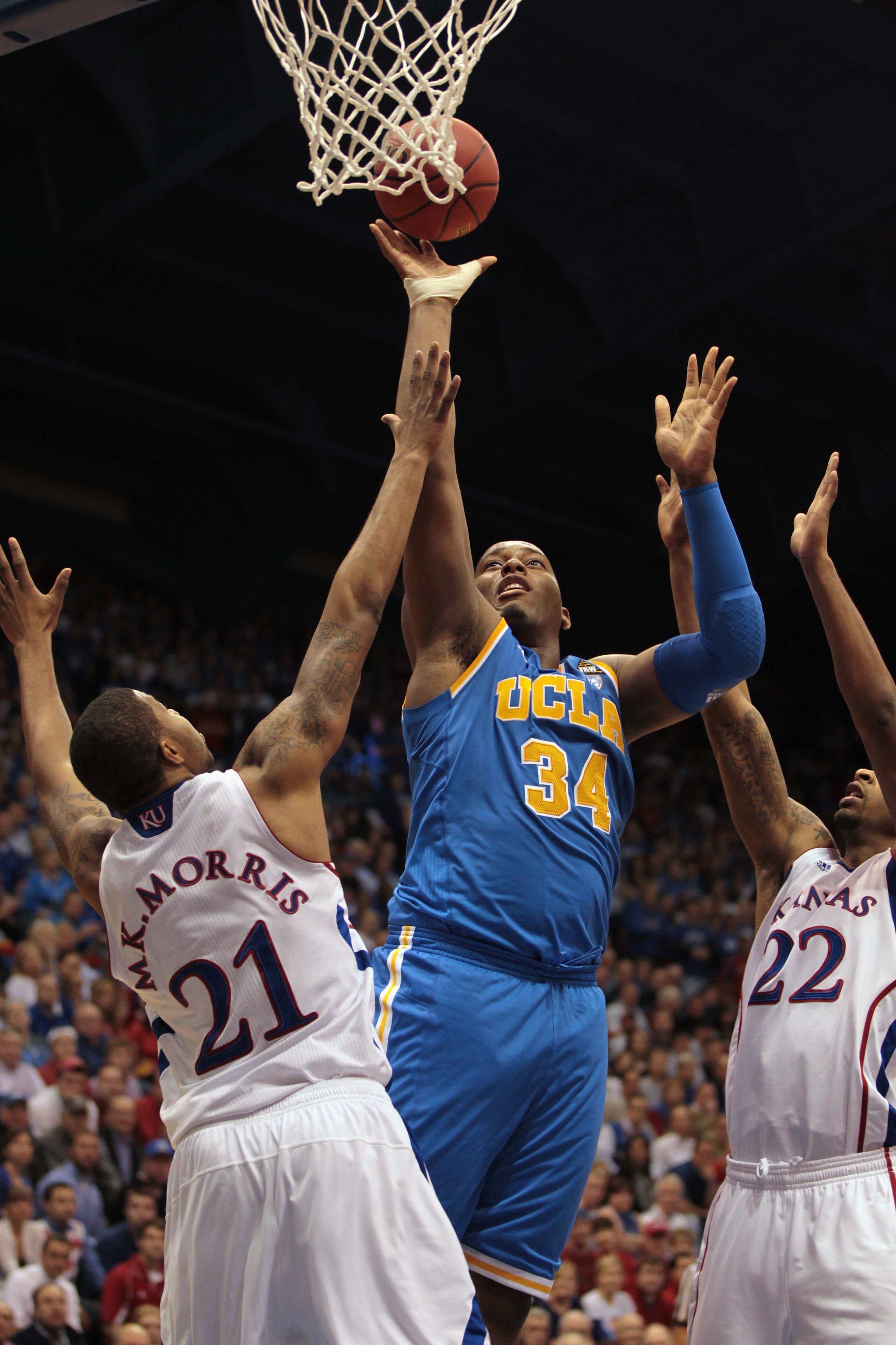 LAWRENCE, KS - DECEMBER 02:  Joshua Smith #34 of the UCLA Bruins shoots over Markieff Morris #21 of the Kansas Jayhawks during the game on December 2, 2010 at Allen Fieldhouse in Lawrence, Kansas.  (Photo by Jamie Squire/Getty Images)
