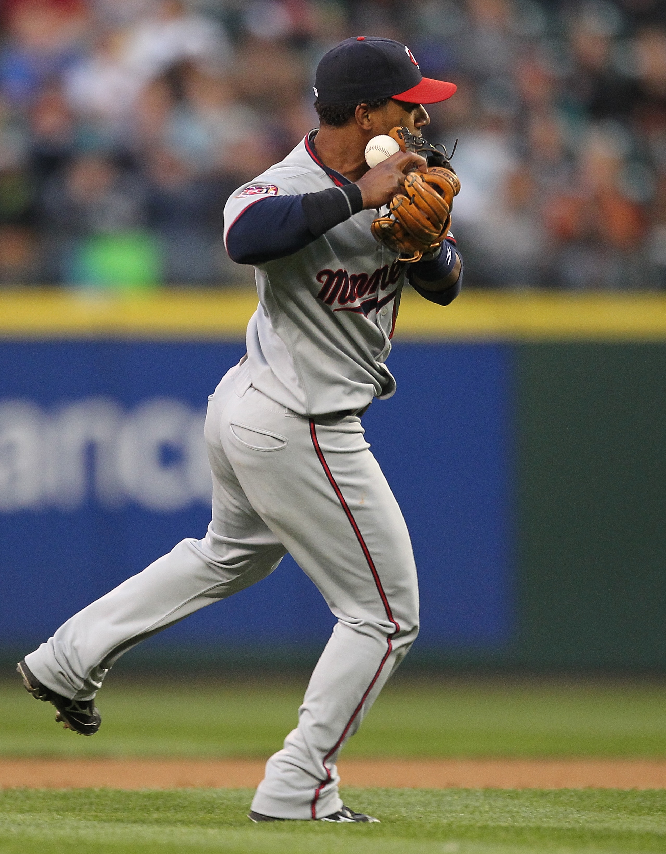 SEATTLE - AUGUST 27:  Shortstop Alexi Casilla #12 of the Minnesota Twins bobbles an infield single by Adam Moore of the Seattle Mariners at Safeco Field on August 27, 2010 in Seattle, Washington. (Photo by Otto Greule Jr/Getty Images)
