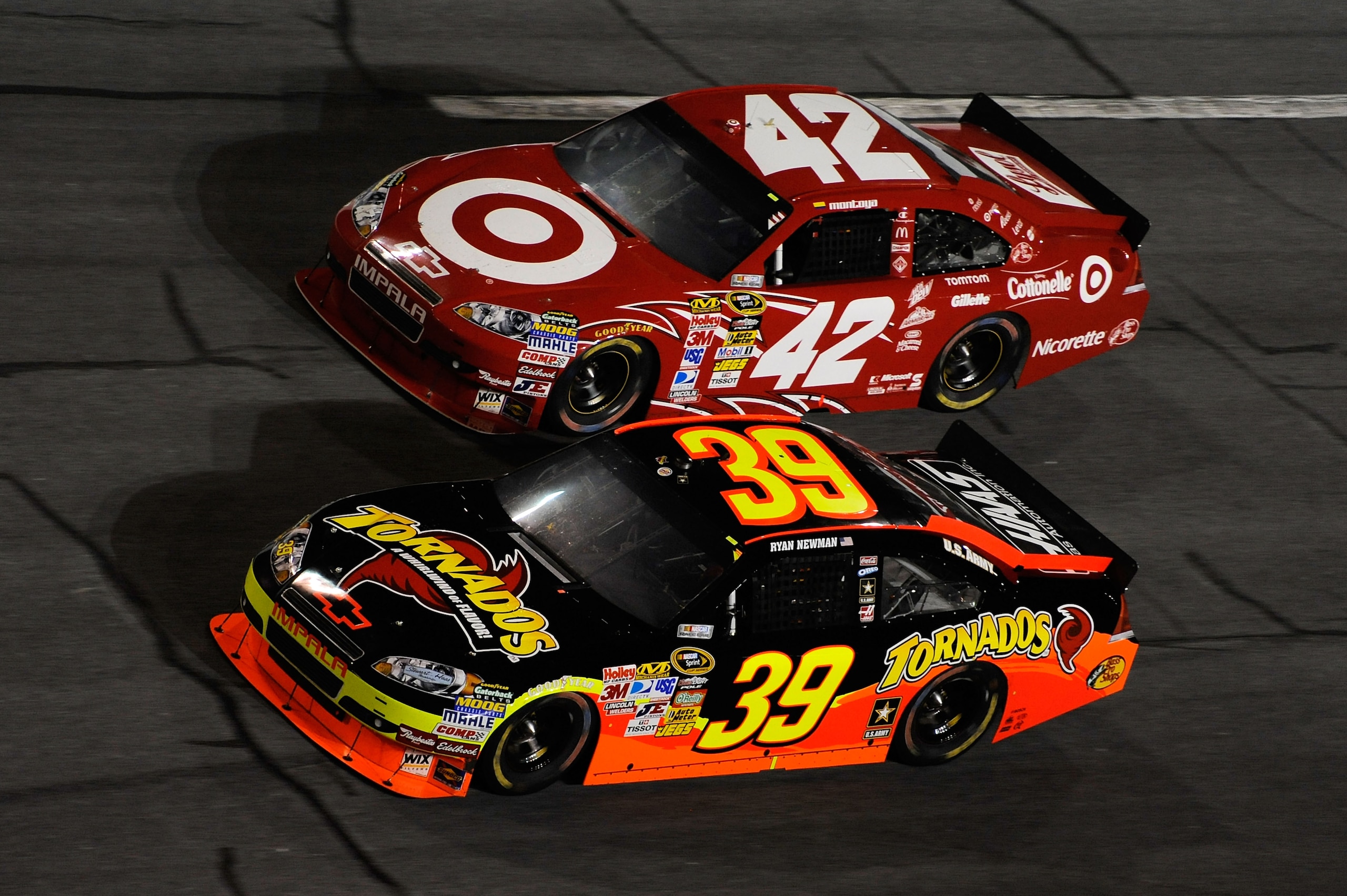 DAYTONA BEACH, FL - JULY 03:  Ryan Newman, driver of the #39 Tornados Chevrolet, and Juan Pablo Montoya, driver of the #42 Target Chevrolet, race side by side during the NASCAR Sprint Cup Series Coke Zero 400 at Daytona International Speedway on July 3, 2