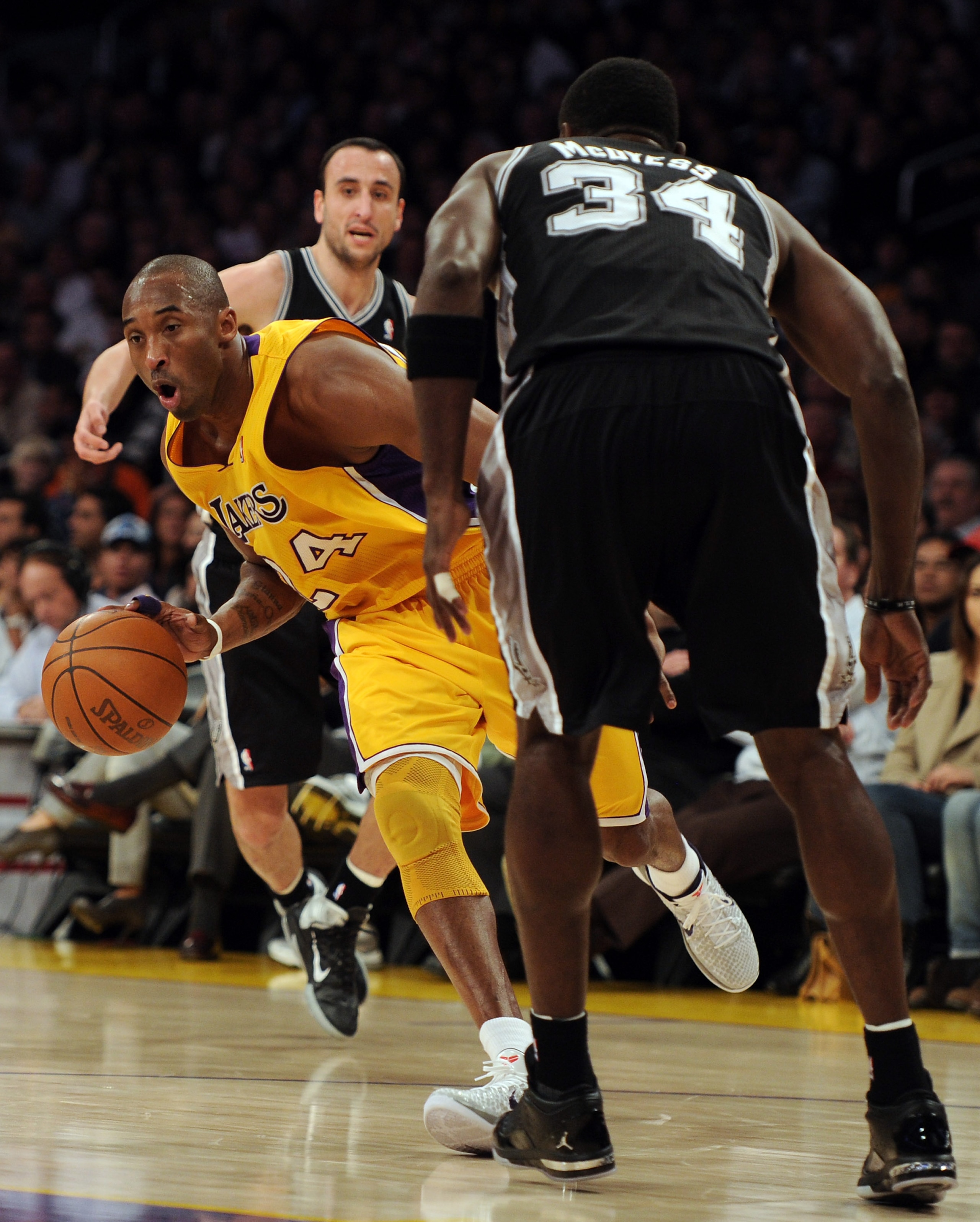 LOS ANGELES, CA - FEBRUARY 03: Kobe Bryant #24 of the Los Angeles Lakers dribbles between Manu Ginobili #20 and Antonio McDyess #34 of the San Antonio Spurs during the first half at Staples Center on February 3, 2011 in Los Angeles, California. NOTE TO LOS ANGELES, CA - FEBRUARY 03: Kobe Bryant #24 of the Los Angeles Lakers dribbles between Manu Ginobili #20 and Antonio McDyess #34 of the San Antonio Spurs during the first half at Staples Center on February 3, 2011 in Los Angeles, California. NOTE TO