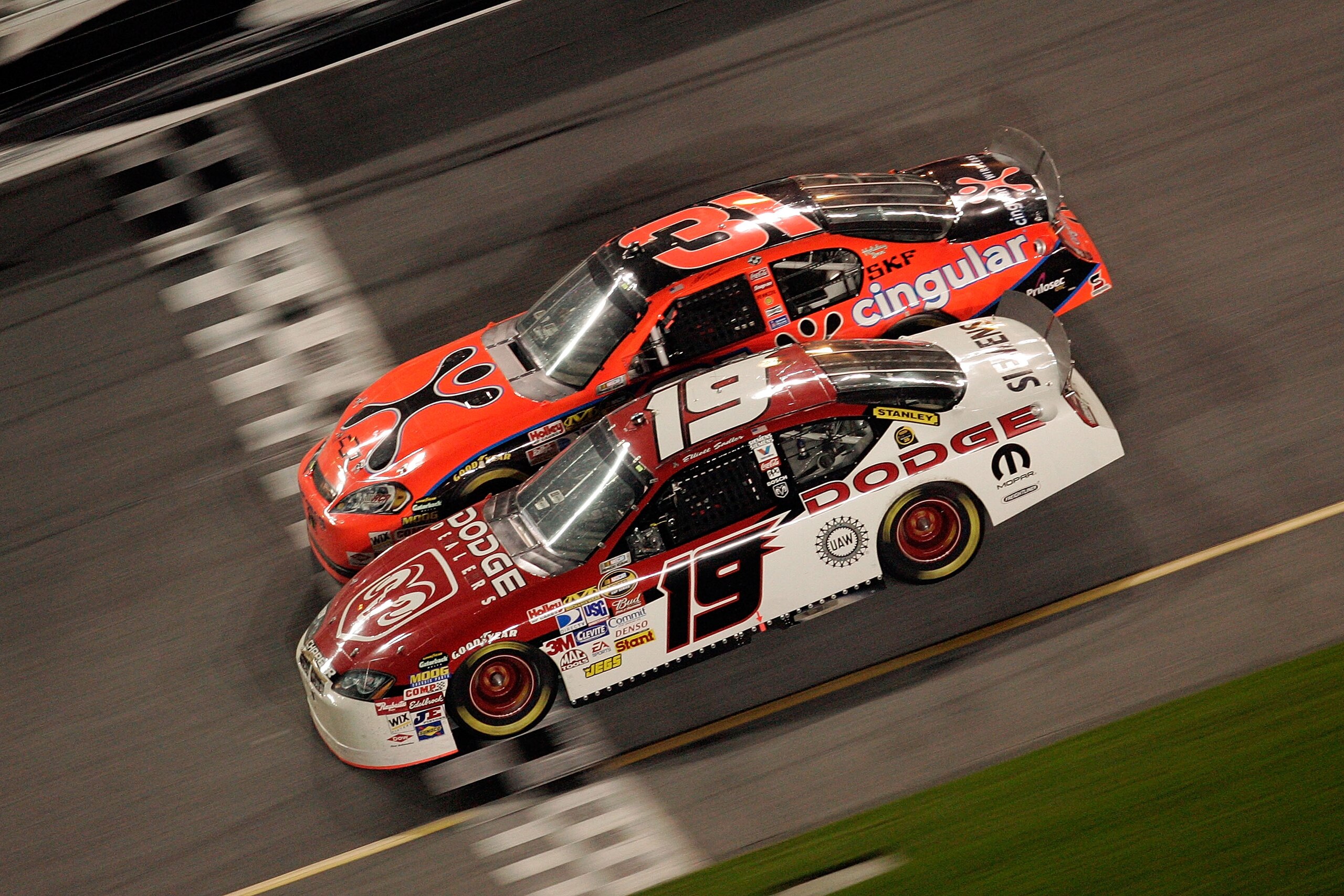 DAYTONA, FL - FEBRUARY 10:  Elliott Sadler, driver of the #19 Dodge Dealers/UAW Dodge, leads Jeff Burton in the #31 Cingular Wireless Chevrolet across the start/finish line during the Budweiser Shootout at Daytona International Speedway on February 10, 20
