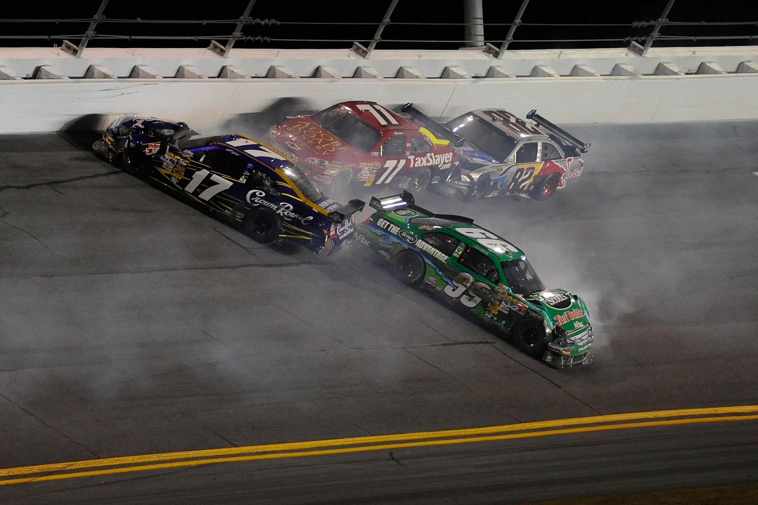 DAYTONA BEACH, FL - FEBRUARY 06:  Carl Edwards, driver of the #99 Scotts Ford and Matt Kenseth, driver of the #17 Crown Royal Ford, lose control of their cars after crashing during the Budweiser Shootout at Daytona International Speedway on February 6, 20