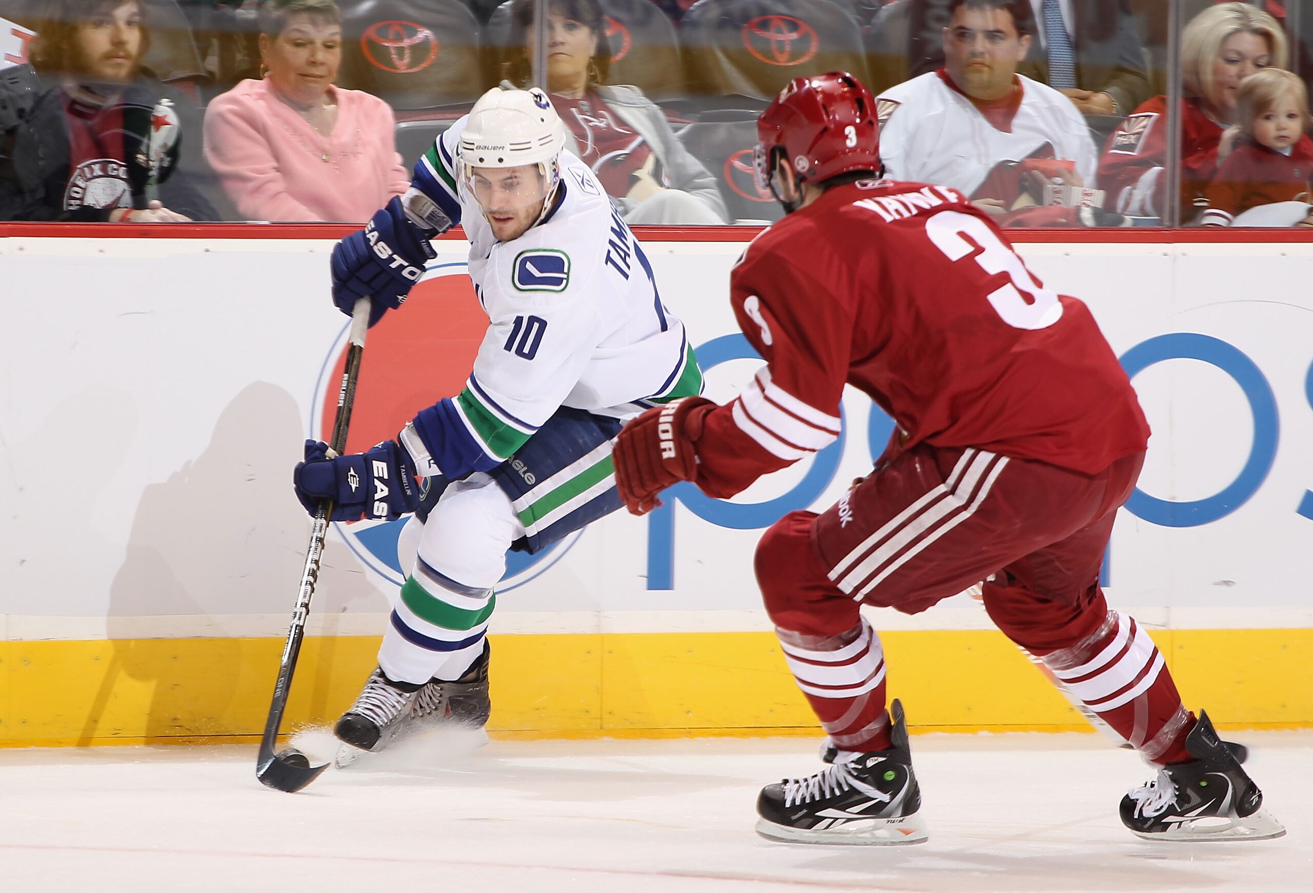 GLENDALE, AZ - FEBRUARY 02: Jeff Tambellini #10 of the Vancouver Canucks skates with the puck under pressure from Keith Yandle #3 of the Phoenix Coyotes during the first period of the NHL game at Jobing.com Arena on February 2, 2011 in Glendale, Arizona. GLENDALE, AZ - FEBRUARY 02: Jeff Tambellini #10 of the Vancouver Canucks skates with the puck under pressure from Keith Yandle #3 of the Phoenix Coyotes during the first period of the NHL game at Jobing.com Arena on February 2, 2011 in Glendale, Arizona.
