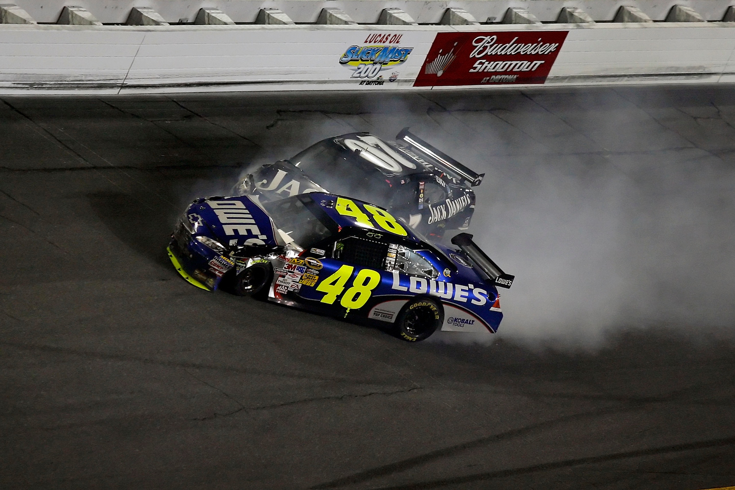 DAYTONA BEACH, FL - FEBRUARY 07: Jimmie Johnson, driver of the #48 Lowe's Chevrolet, suffers damage along side Casey Mears, driver of the #97 Jack Daniel's Chevrolet, during the NASCAR Sprint Cup Series Budweiser Shootout at Daytona International Speedway