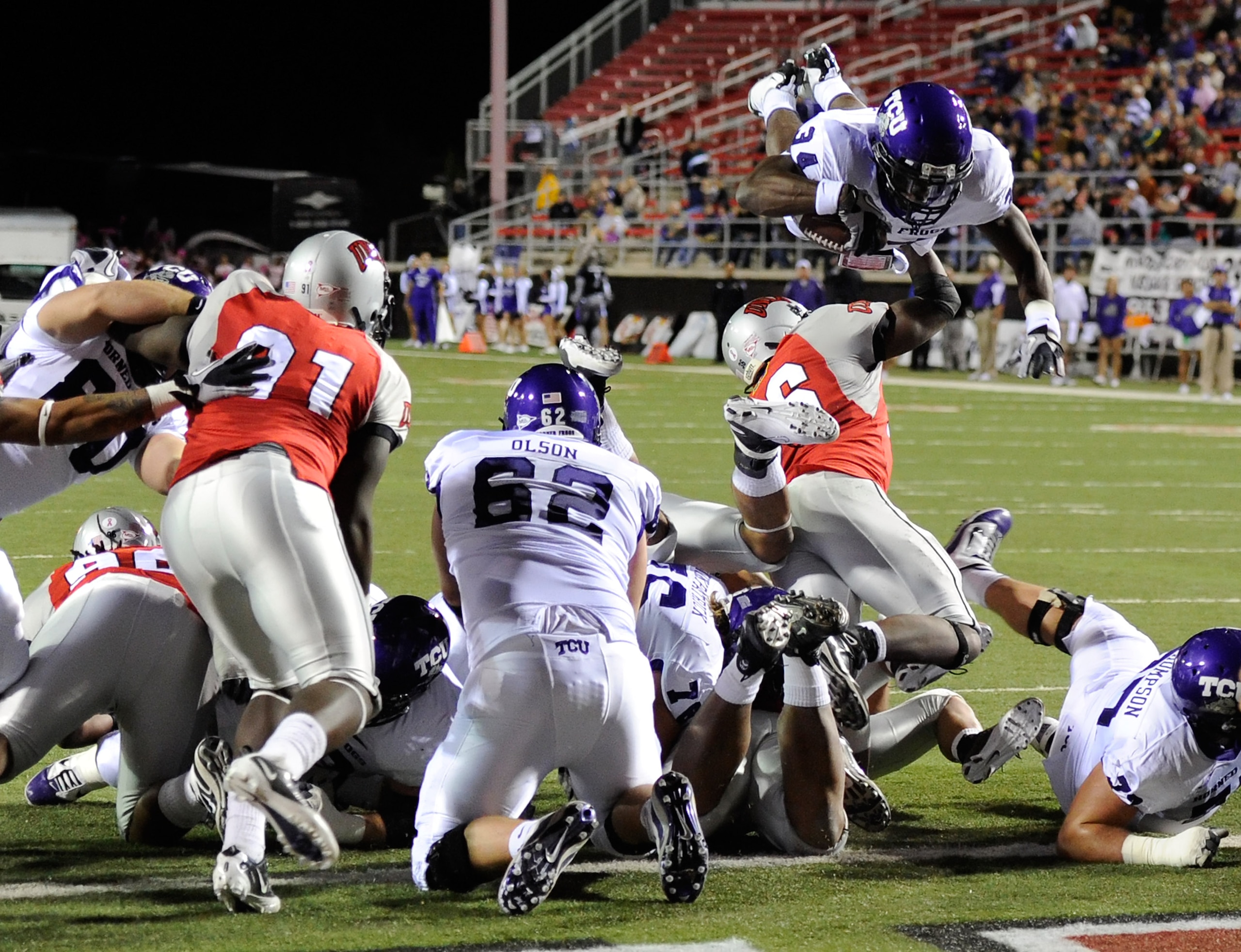 LAS VEGAS - OCTOBER 30:  Ed Wesley #34 of the Texas Christian University Horned Frogs jumps over players at the goal line to score a touchdown against the UNLV Rebels during the second quarter of their game at Sam Boyd Stadium October 30, 2010 in Las Vega
