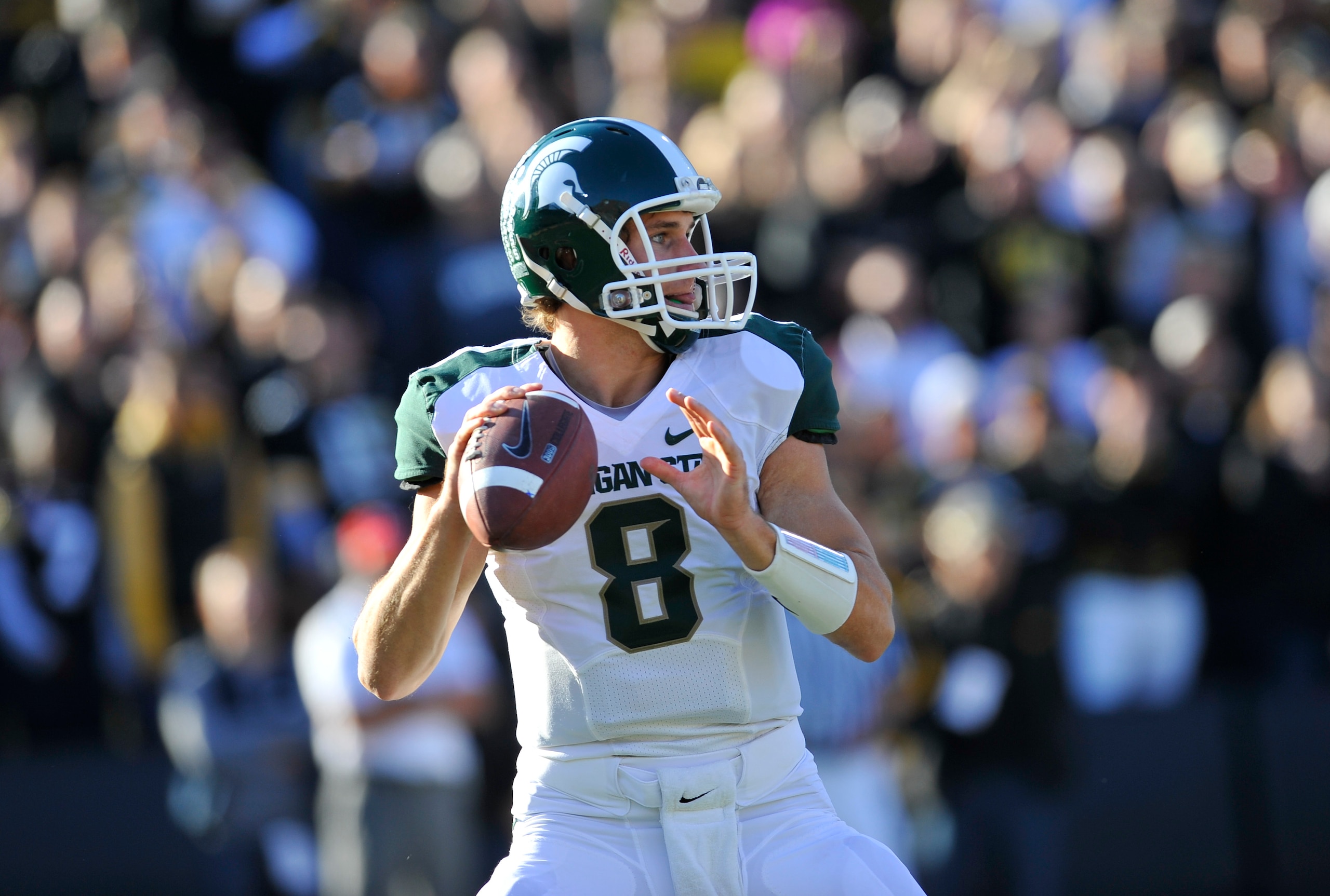 IOWA CITY, IA - OCTOBER 30- Quarterback Kirk Cousins #8 of the Michigan State Spartans looks down field for a receiver during play against the University of Iowa Hawkeyes at Kinnick Stadium on October 30, 2010 in Iowa City, Iowa. Iowa won 37-6 over Michig