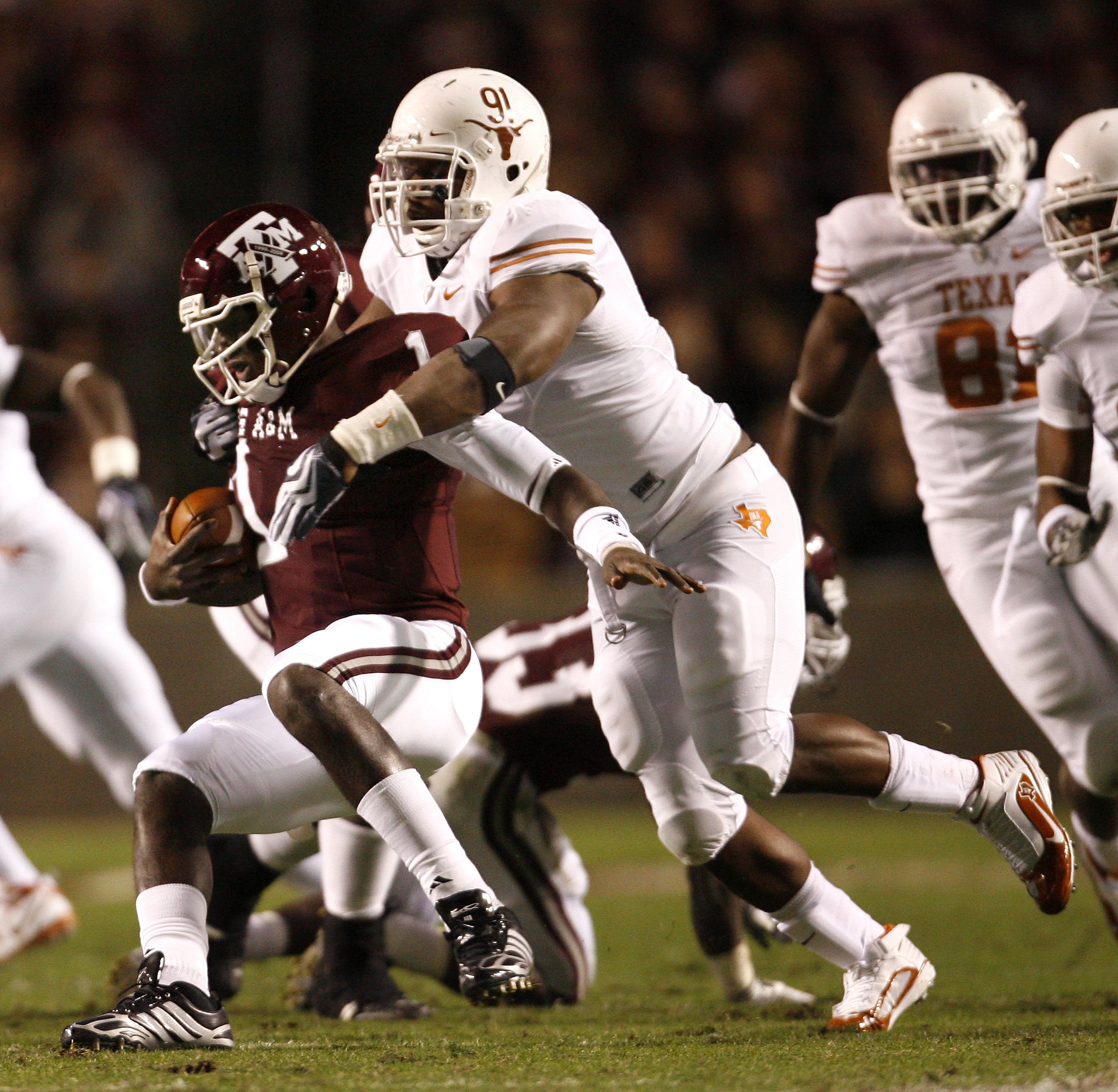 COLLEGE STATION, TX - NOVEMBER 26: Defensive tackle Kheeston Randall #91 of the Texas Longhorns sacks quarterback Jerrod Johnson #1 of the Texas A&M Aggies for a loss in the first half at Kyle Field on November 26, 2009 in College Station, Texas. The Long