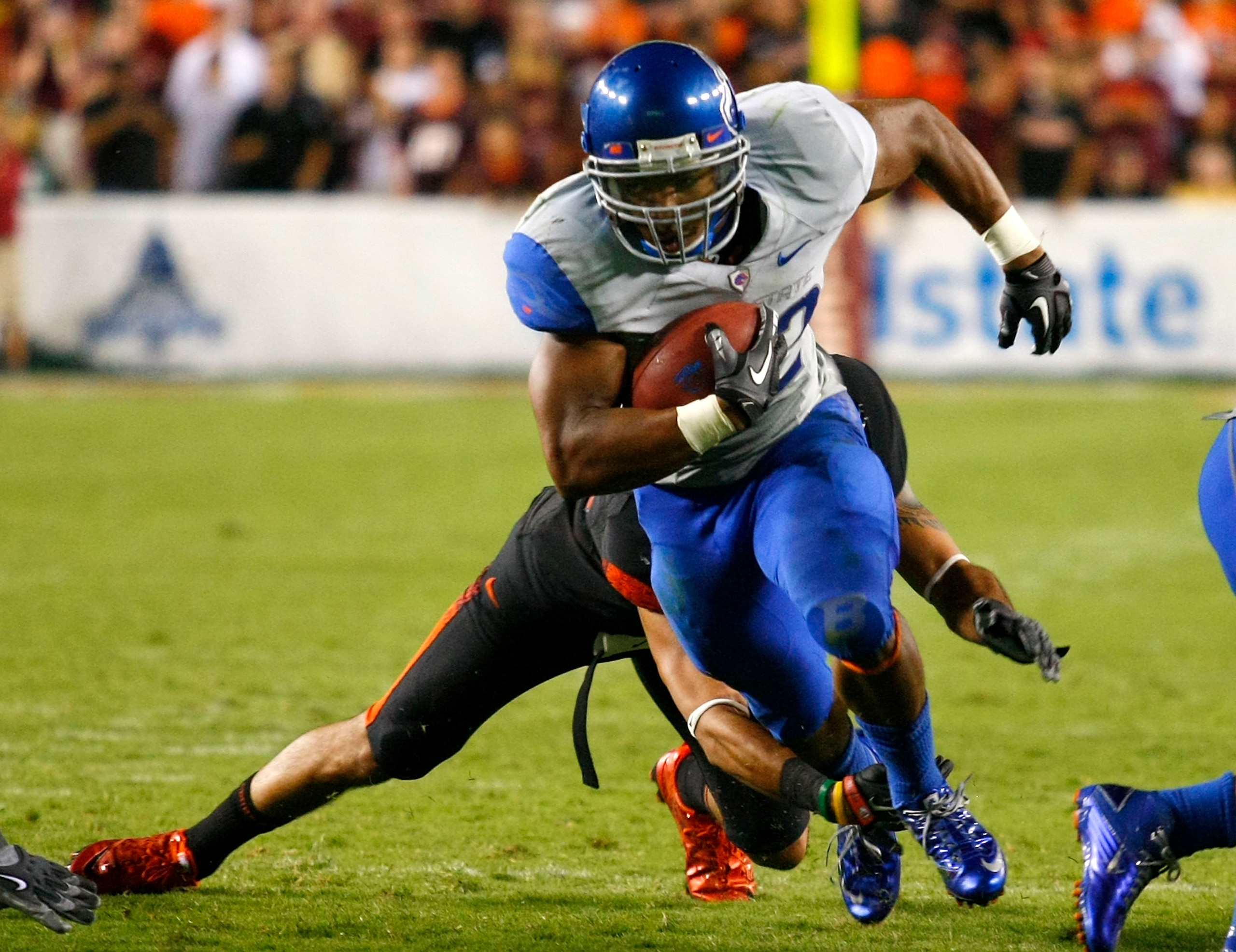 LANDOVER, MD - SEPTEMBER 06:  Running back #22 Doug Martin of the Boise State Broncos runs past linebacker #43 Jeron Gouveia-Winslow of the Virginia Tech Hokies at FedExField on September 6, 2010 in Landover, Maryland.  (Photo by Geoff Burke/Getty Images)