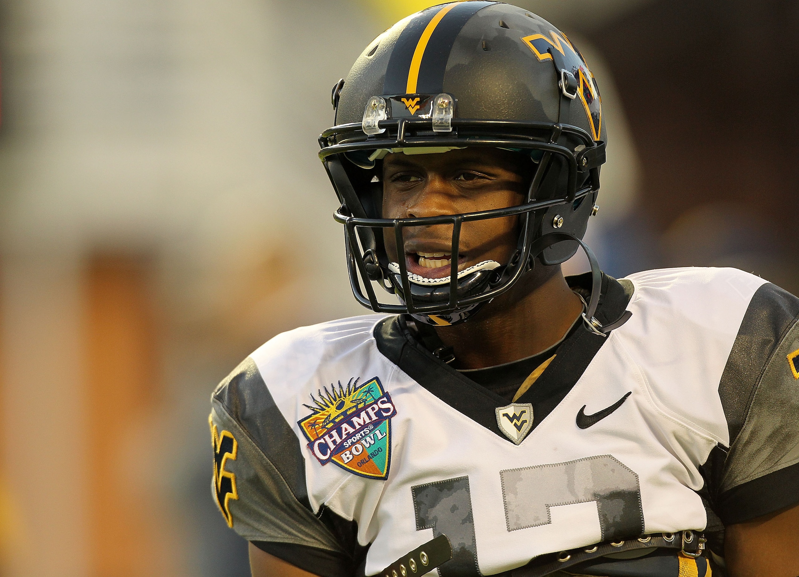 ORLANDO, FL - DECEMBER 28: Geno Smith #12 of the West Virginia Mountineers warms up during the Champs Sports Bowl against the North Carolina State Wolfpack at Florida Citrus Bowl Stadium on December 28, 2010 in Orlando, Florida.  (Photo by Mike Ehrmann/Ge