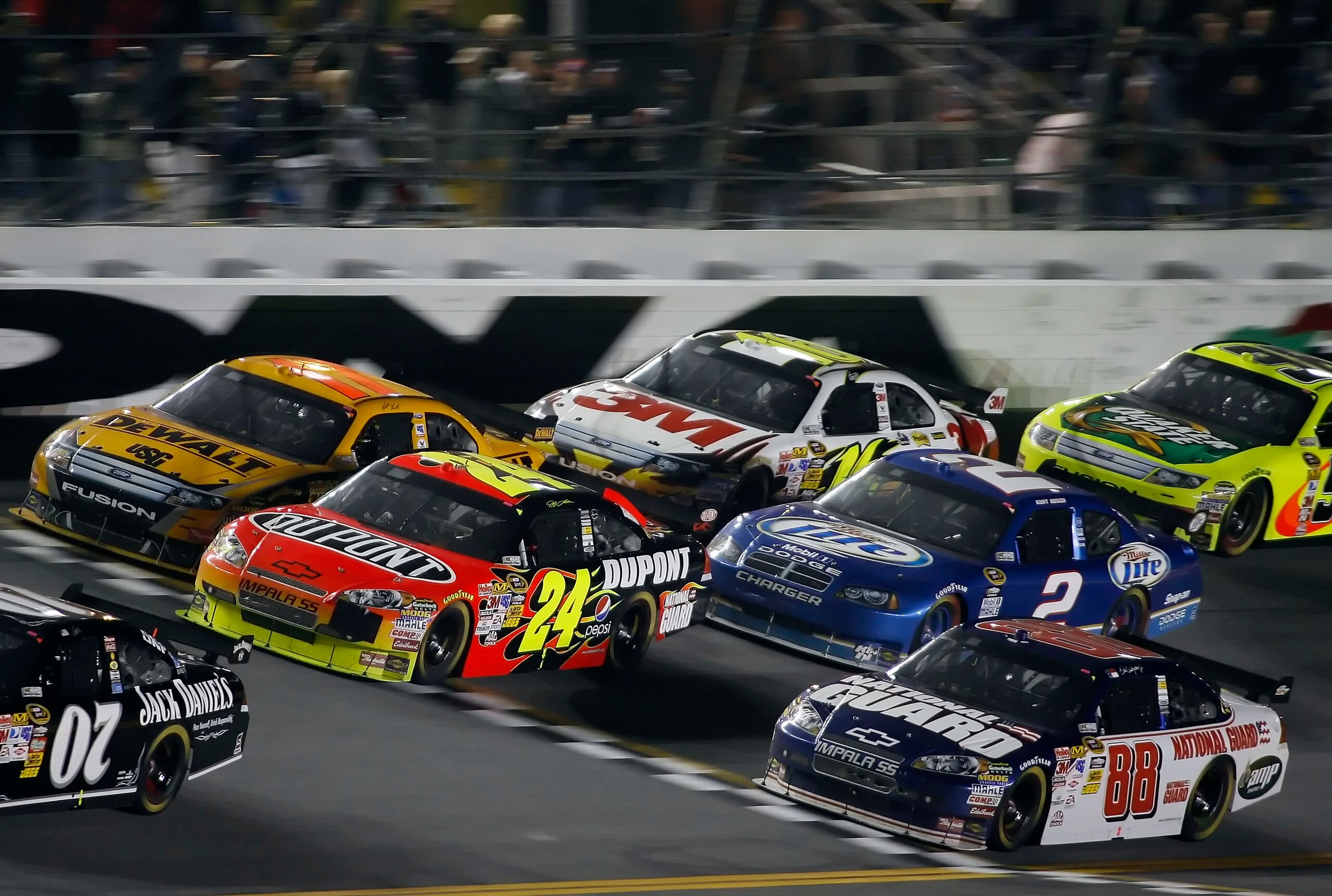 DAYTONA BEACH, FL - FEBRUARY 07:  Jeff Gordon, driver of the #24 DuPont Chevrolet, races with Dale Earnhardt, Jr., driver of the #88 National Guard/AMP Energy Chevrolet, and Matt Kenseth, driver of the #17 DEWALT Ford during the NASCAR Sprint Cup Series B