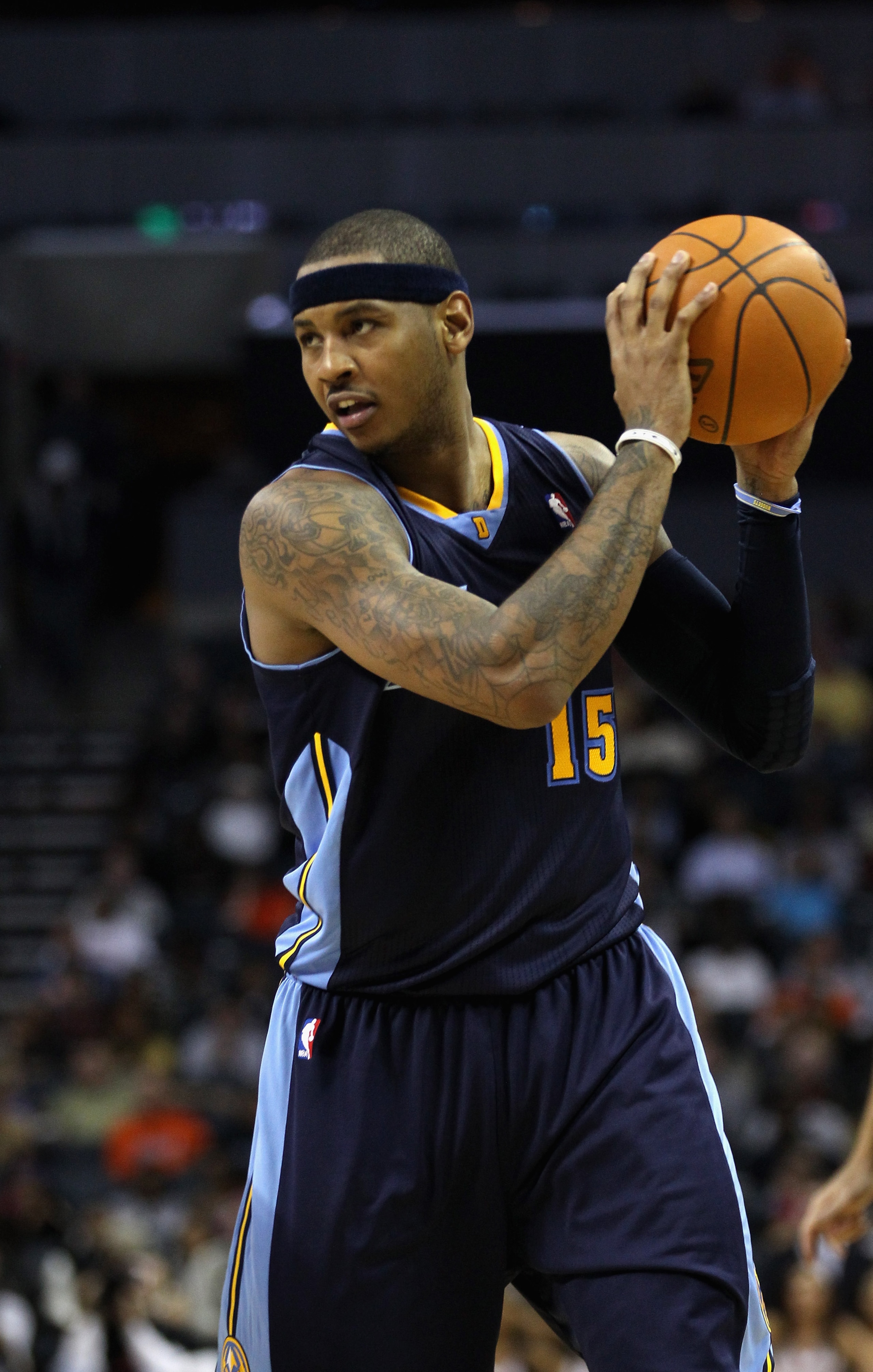 CHARLOTTE, NC - DECEMBER 07:  Carmelo Anthony #15 of the Denver Nuggets watches on against the Charlotte Bobcats during their game at Time Warner Cable Arena on December 7, 2010 in Charlotte, North Carolina.  NOTE TO USER: User expressly acknowledges and