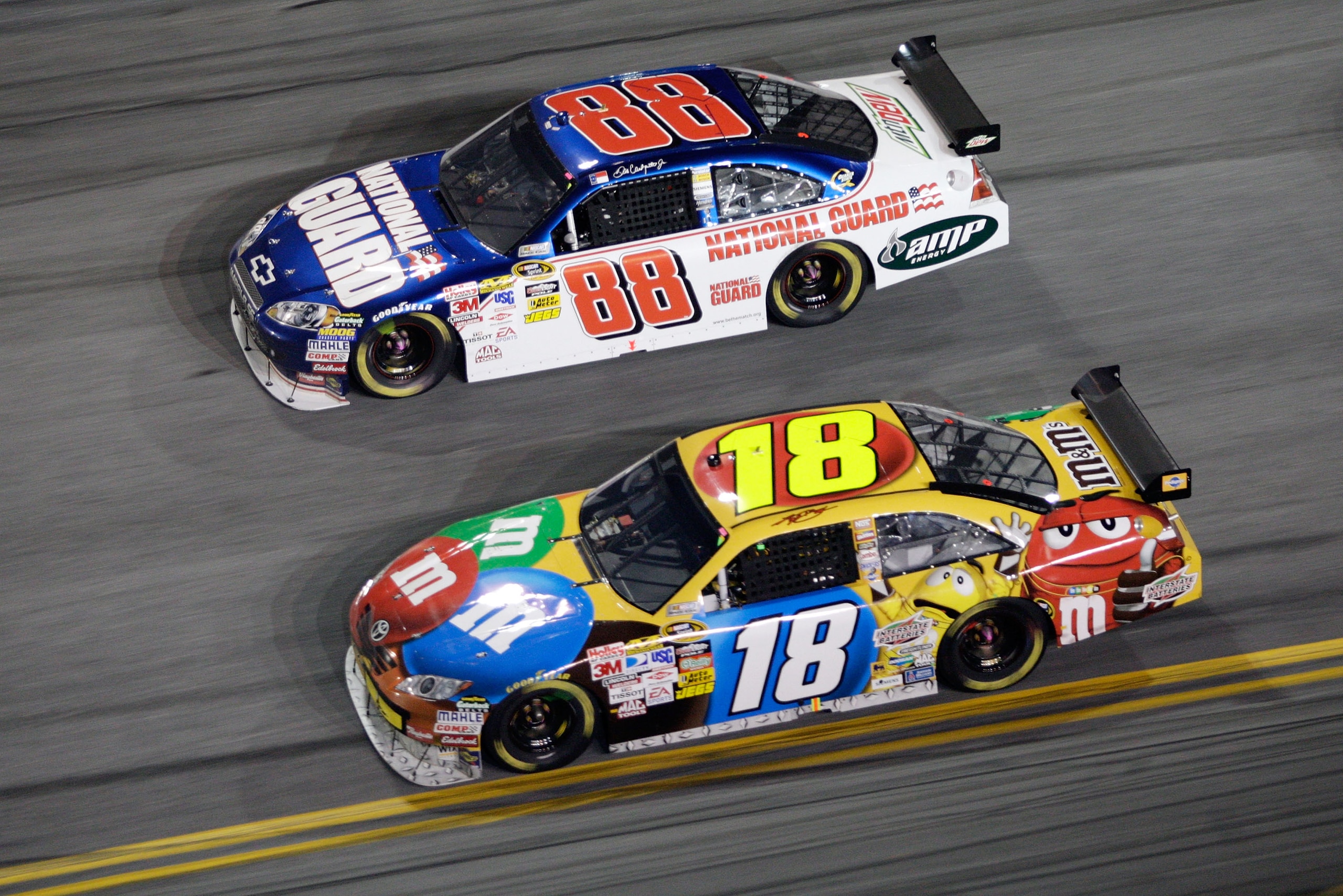 DAYTONA BEACH, FL - FEBRUARY 07: Dale Earnhardt Jr., driver of the #88 National Guard Chevrolet, races Kyle Busch, driver of the #18 M&M's Toyota, during the NASCAR Sprint Cup Series Budweiser Shootout at Daytona International Speedway on February 7, 2009