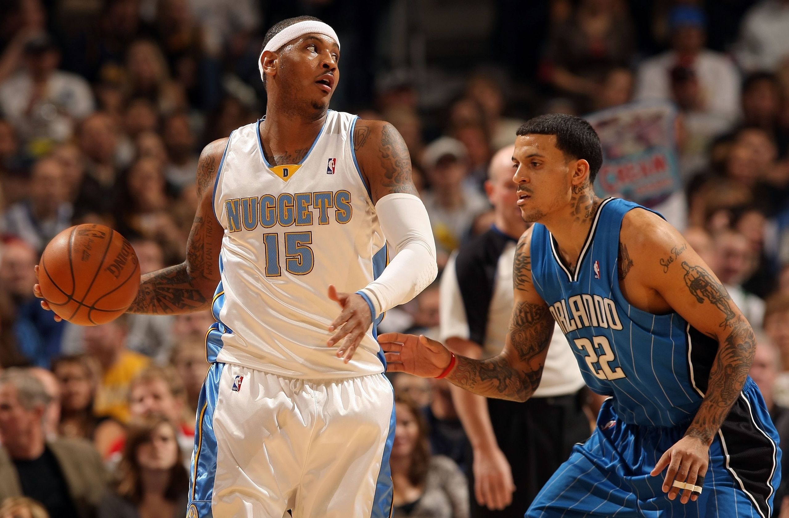 DENVER - JANUARY 13:  Carmelo Anthony #15 of the Denver Nuggets controls the ball against Matt Barnes #22 of the Orlando Magic during NBA action at Pepsi Center on January 13, 2010 in Denver, Colorado. The Nuggets defeated the Magic 115-97. NOTE TO USER: 