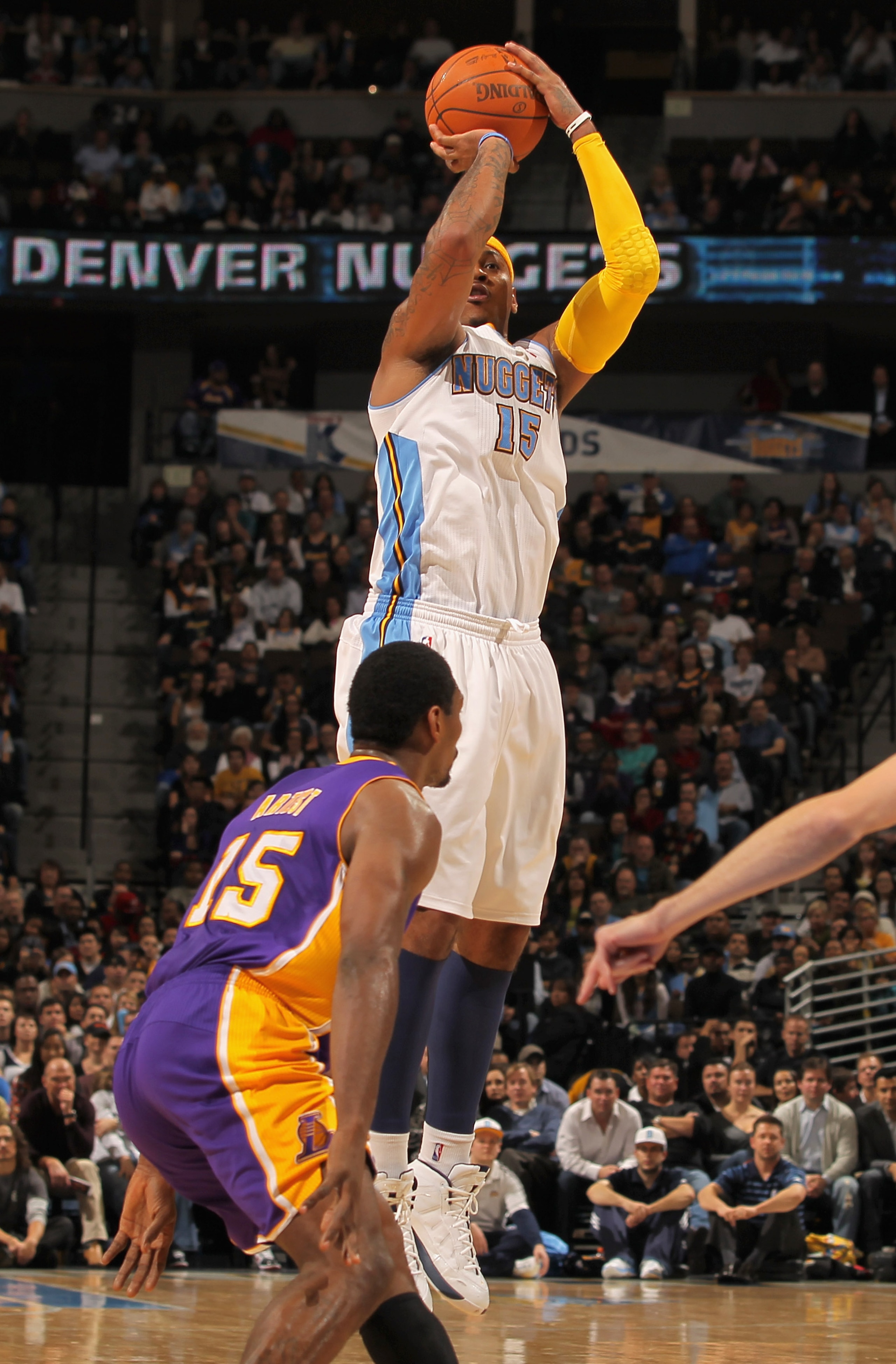 DENVER - NOVEMBER 11:  Carmelo Anthony #15 of the Denver Nuggets takes a shot over Ron Artest #15 of the Los Angeles Lakers at the Pepsi Center on November 11, 2010 in Denver, Colorado. The Nuggets defeated the Lakers 118-112.  NOTE TO USER: User expressl