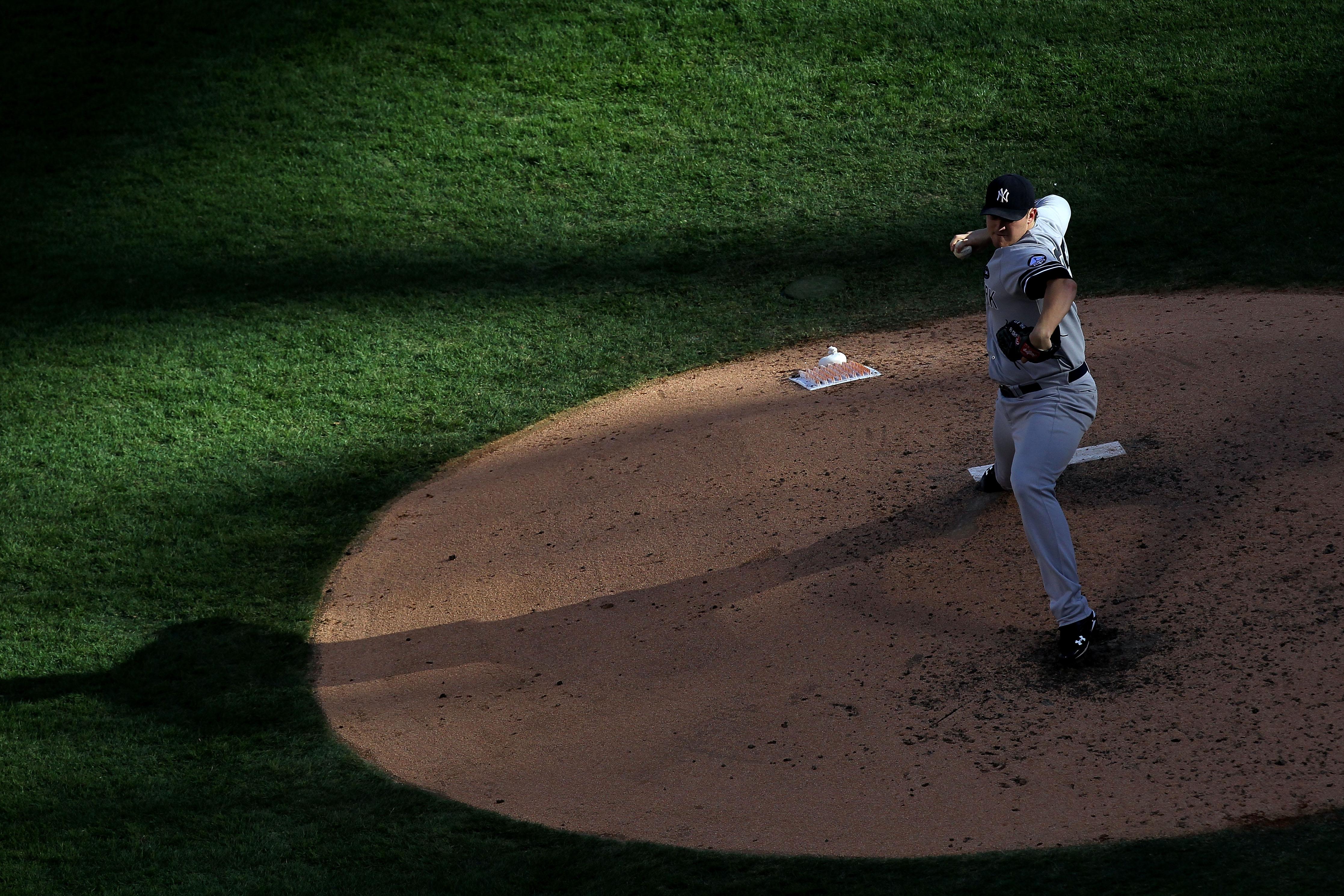 ARLINGTON, TX - OCTOBER 16:  Phil Hughes #65 of the New York Yankees throws a pitch against the Texas Rangers in Game Two of the ALCS during the 2010 MLB Playoffs at Rangers Ballpark in Arlington on October 16, 2010 in Arlington, Texas.  (Photo by Ronald