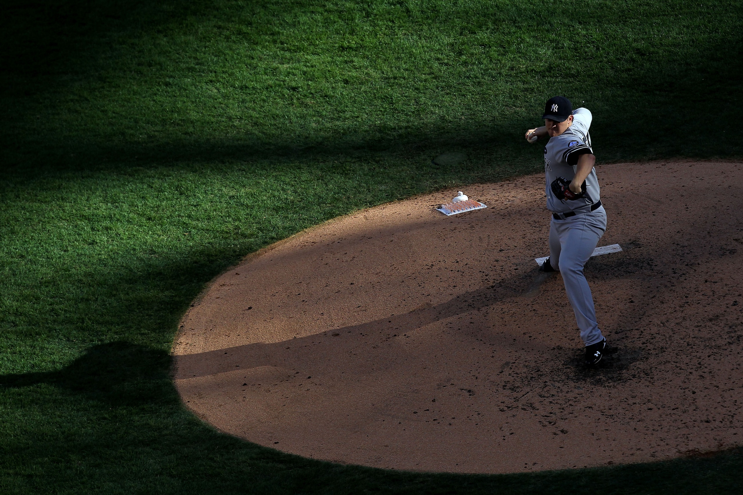 ARLINGTON, TX - OCTOBER 16:  Phil Hughes #65 of the New York Yankees throws a pitch against the Texas Rangers in Game Two of the ALCS during the 2010 MLB Playoffs at Rangers Ballpark in Arlington on October 16, 2010 in Arlington, Texas.  (Photo by Ronald