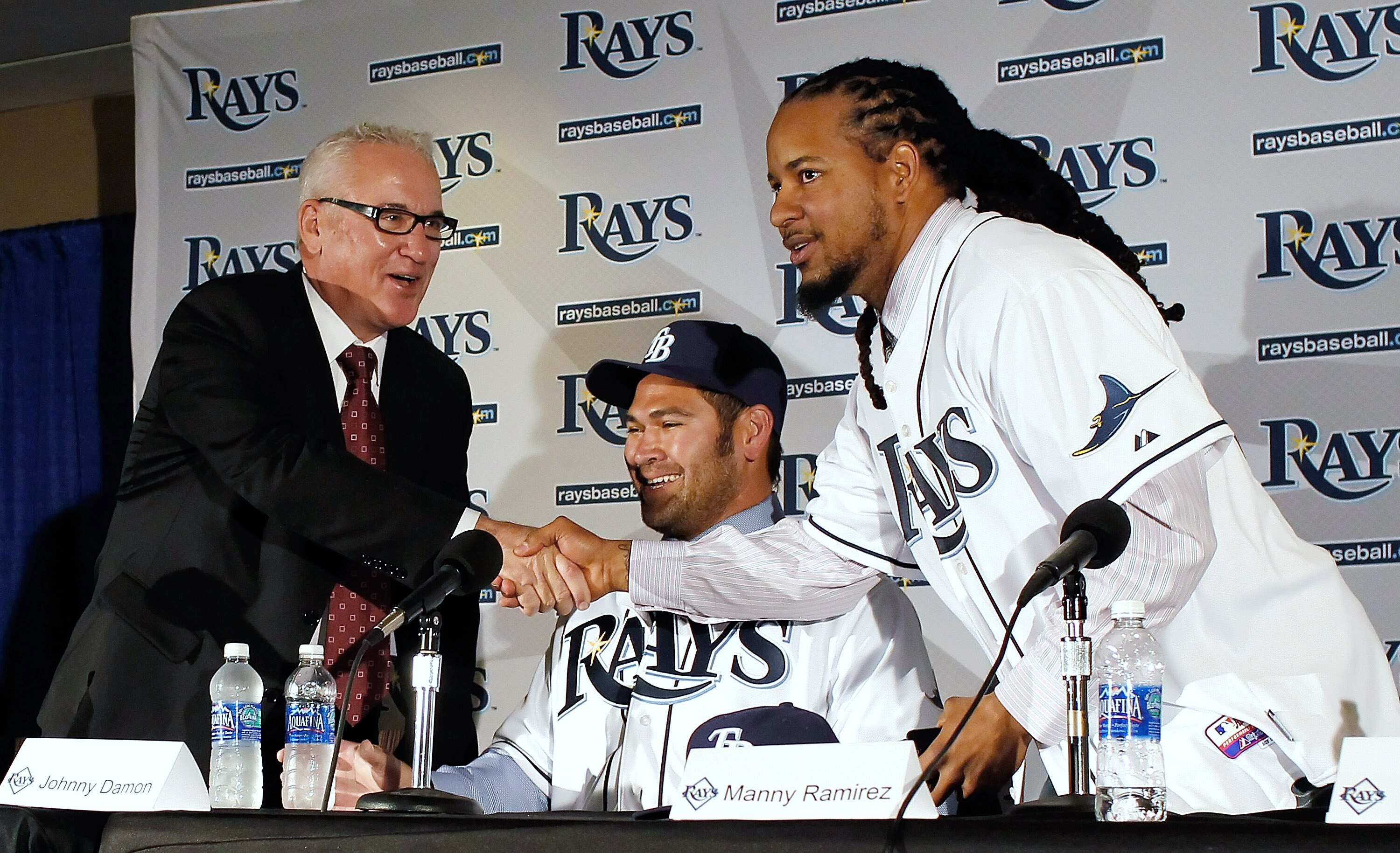 ST PETERSBURG, FL - FEBRUARY 01:  The Tampa Bay Rays manager Joe Maddon shakes hands with Manny Ramirez #24 of the Tampa Bay Rays as Johnny Damon #22 of the Tampa Bay Rays looks on during a press conference at Tropicana Field on February 1, 2011 in St. Pe