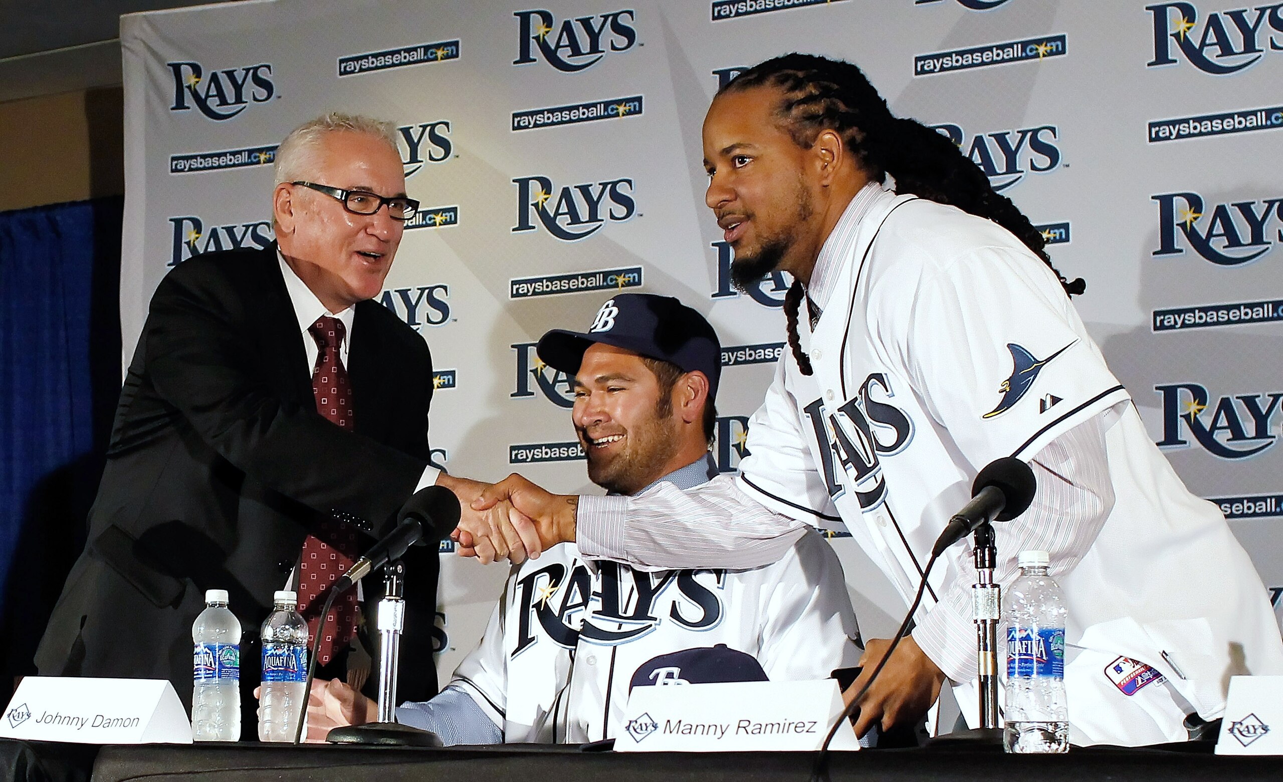 ST PETERSBURG, FL - FEBRUARY 01:  The Tampa Bay Rays manager Joe Maddon shakes hands with Manny Ramirez #24 of the Tampa Bay Rays as Johnny Damon #22 of the Tampa Bay Rays looks on during a press conference at Tropicana Field on February 1, 2011 in St. Pe