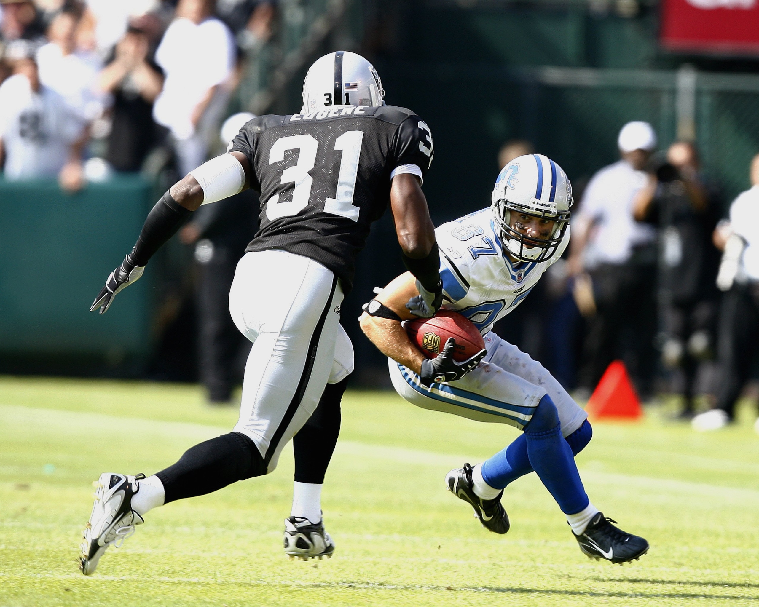 OAKLAND, CA - SEPTEMBER 9:  Wide receiver Mike Furrey #87 of the Detroit Lions tries to put a move on safety Hiram Eugene of the Oakland Raiders at McAfee Coliseum on September 9, 2007 in Oakland, California.  The Lions defeated the Raiders 36-21 (Photo b