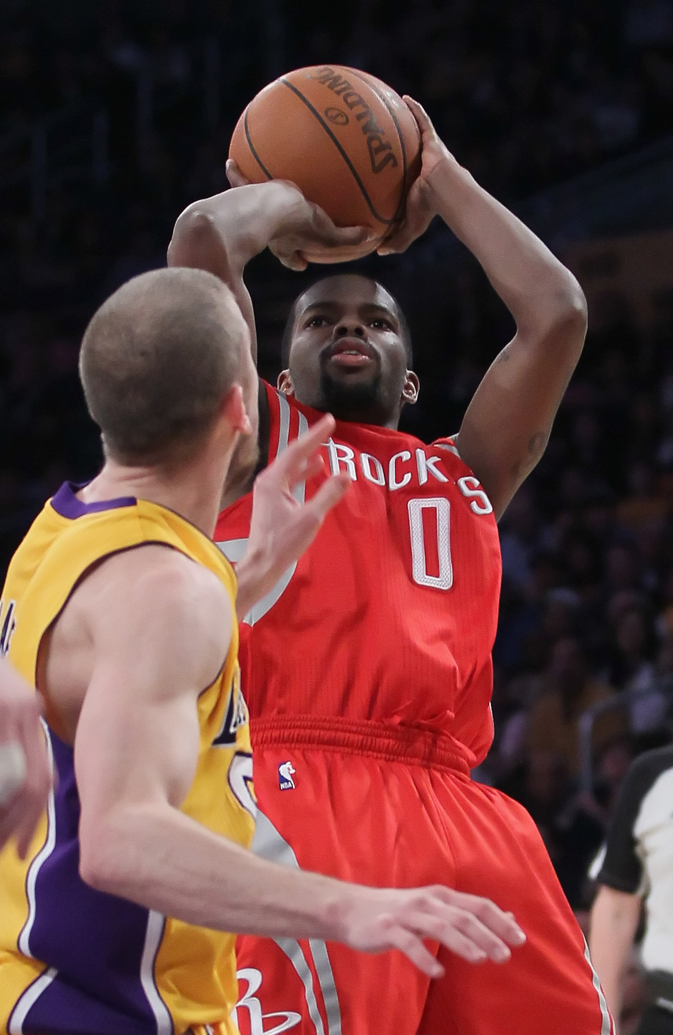 LOS ANGELES, CA - FEBRUARY 01:  Aaron Brooks #0 of the Houston Rockets shoots over Steve Blake #5 of the Los Angeles Lakers in the second half at Staples Center on February 1, 2011 in Los Angeles, California. The Lakers defeated the Rockets 114-106. NOTE