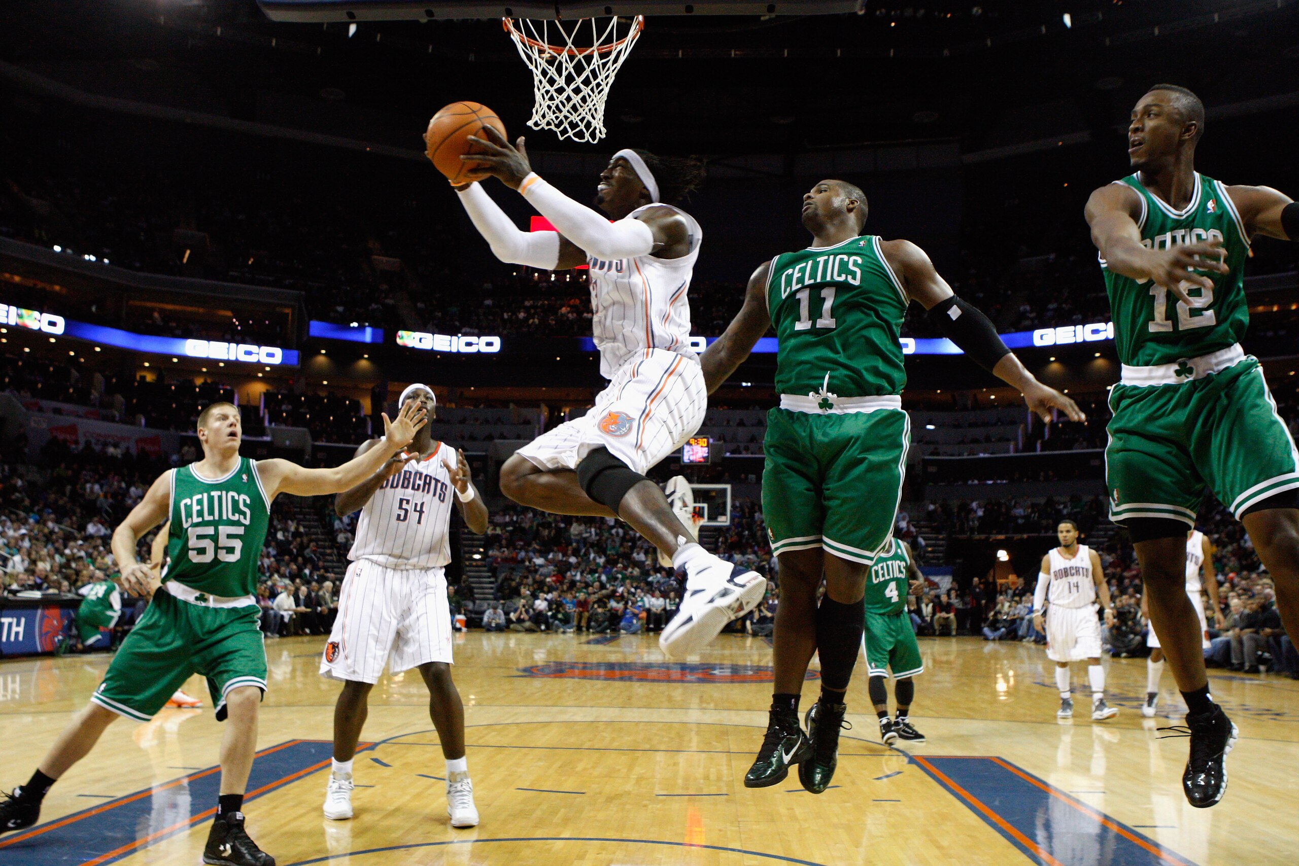 CHARLOTTE, NC - DECEMBER 11:  Glen Davis #11 of the Boston Celtics watches as Gerald Wallace #3 of the Charlotte Bobcats drives to the basket during their game at Time Warner Cable Arena on December 11, 2010 in Charlotte, North Carolina. NOTE TO USER: Use