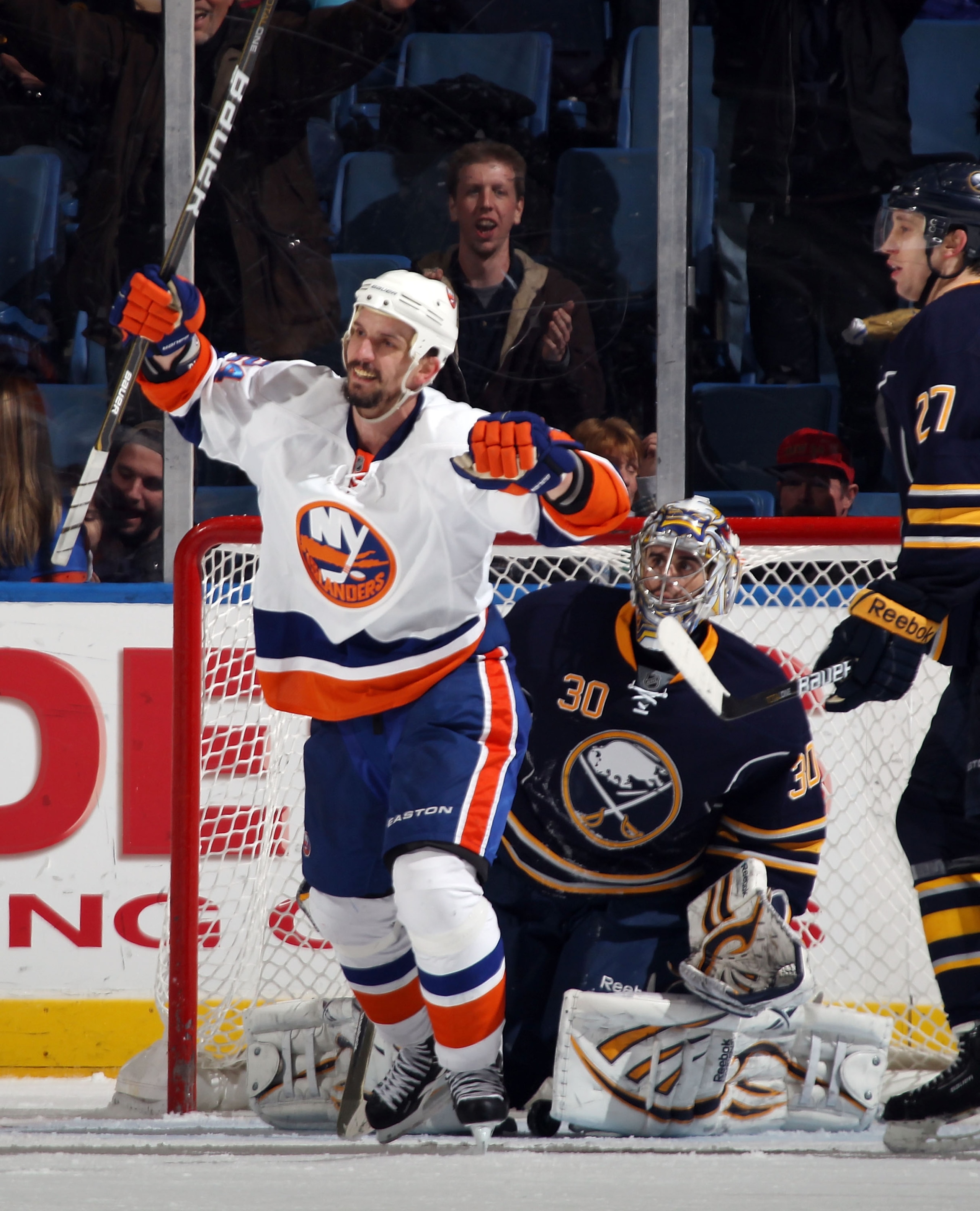 UNIONDALE, NY - JANUARY 23: Radek Martinek #24 of the New York Islanders celebrates a third period goal by teammate Jack Hillen #38 (not shown) against Ryan Miller #30 of the Buffalo Sabres at the Nassau Coliseum on January 23, 2011 in Uniondale, New York UNIONDALE, NY - JANUARY 23: Radek Martinek #24 of the New York Islanders celebrates a third period goal by teammate Jack Hillen #38 (not shown) against Ryan Miller #30 of the Buffalo Sabres at the Nassau Coliseum on January 23, 2011 in Uniondale, New York