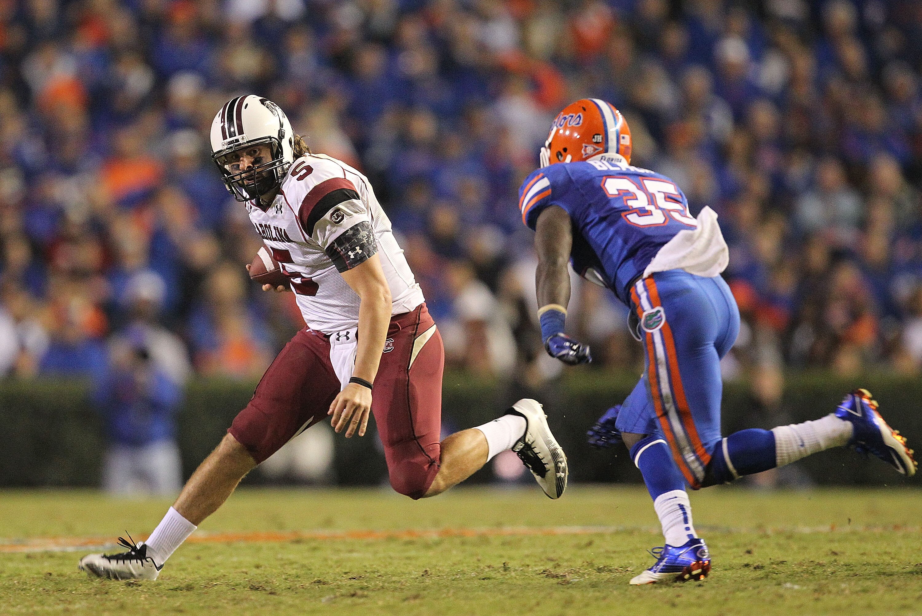 GAINESVILLE, FL - NOVEMBER 13:  Stephen Garcia #5 of the South Carolina Gamecocks rushes against Ahmad Black #35 of the Florida Gators during a game at Ben Hill Griffin Stadium on November 13, 2010 in Gainesville, Florida. The Gamecocks beat the Gators 36