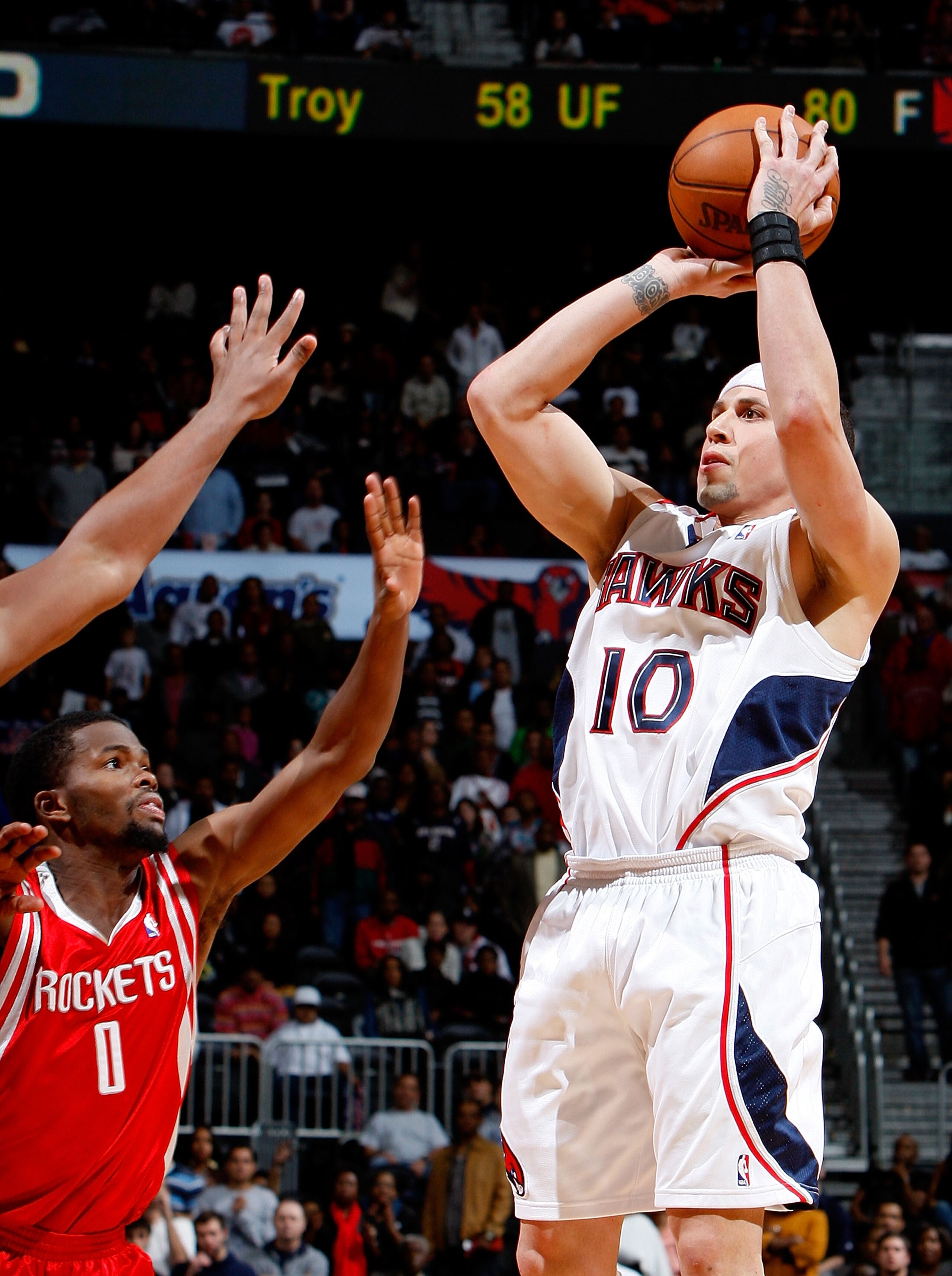 ATLANTA - NOVEMBER 20:  Mike Bibby #10 of the Atlanta Hawks shoots over Aaron Brooks #0 of the Houston Rockets in the final seconds of the game at Philips Arena on November 20, 2009 in Atlanta, Georgia.  NOTE TO USER: User expressly acknowledges and agree