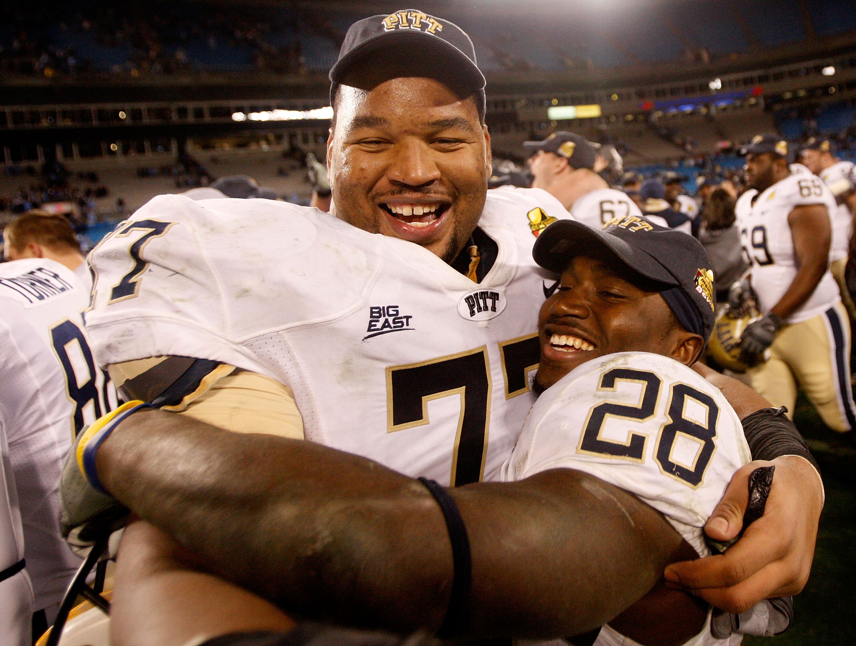 CHARLOTTE, NC - DECEMBER 26:  Teammates Jason Pinkston #77 and Dion Lewis #28 of the Pittsburgh Panthers celebrates after a 19-17 victory over the North Carolina Tar Heels on December 26, 2009 in Charlotte, North Carolina.  (Photo by Streeter Lecka/Getty