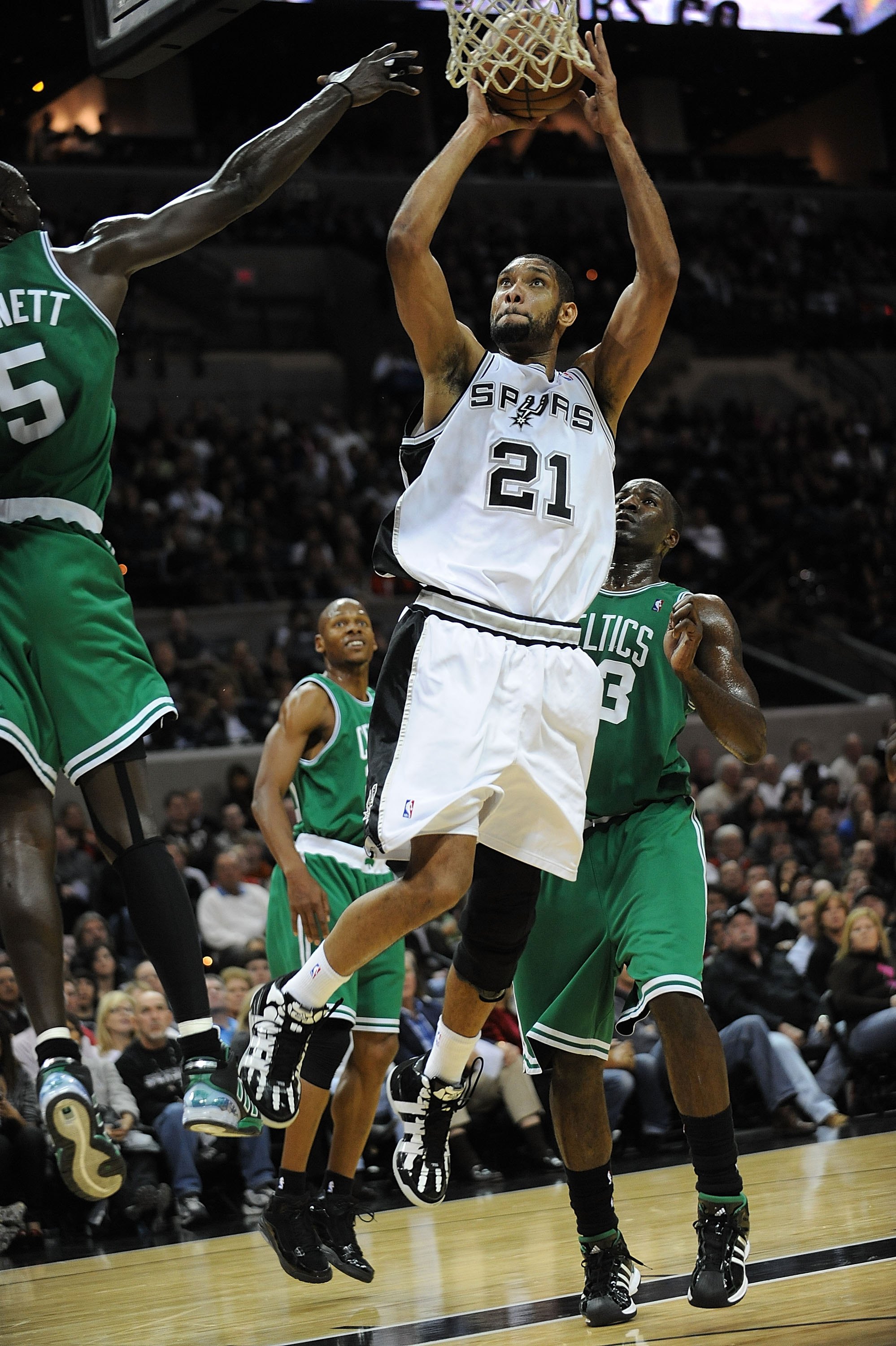 SAN ANTONIO - DECEMBER 03:  Forward Tim Duncan #21 of the San Antonio Spurs takes a shot against Kevin Garnett #5 of the Boston Celtics on December 3, 2009 at AT&T Center in San Antonio, Texas.  NOTE TO USER: User expressly acknowledges and agrees that, b