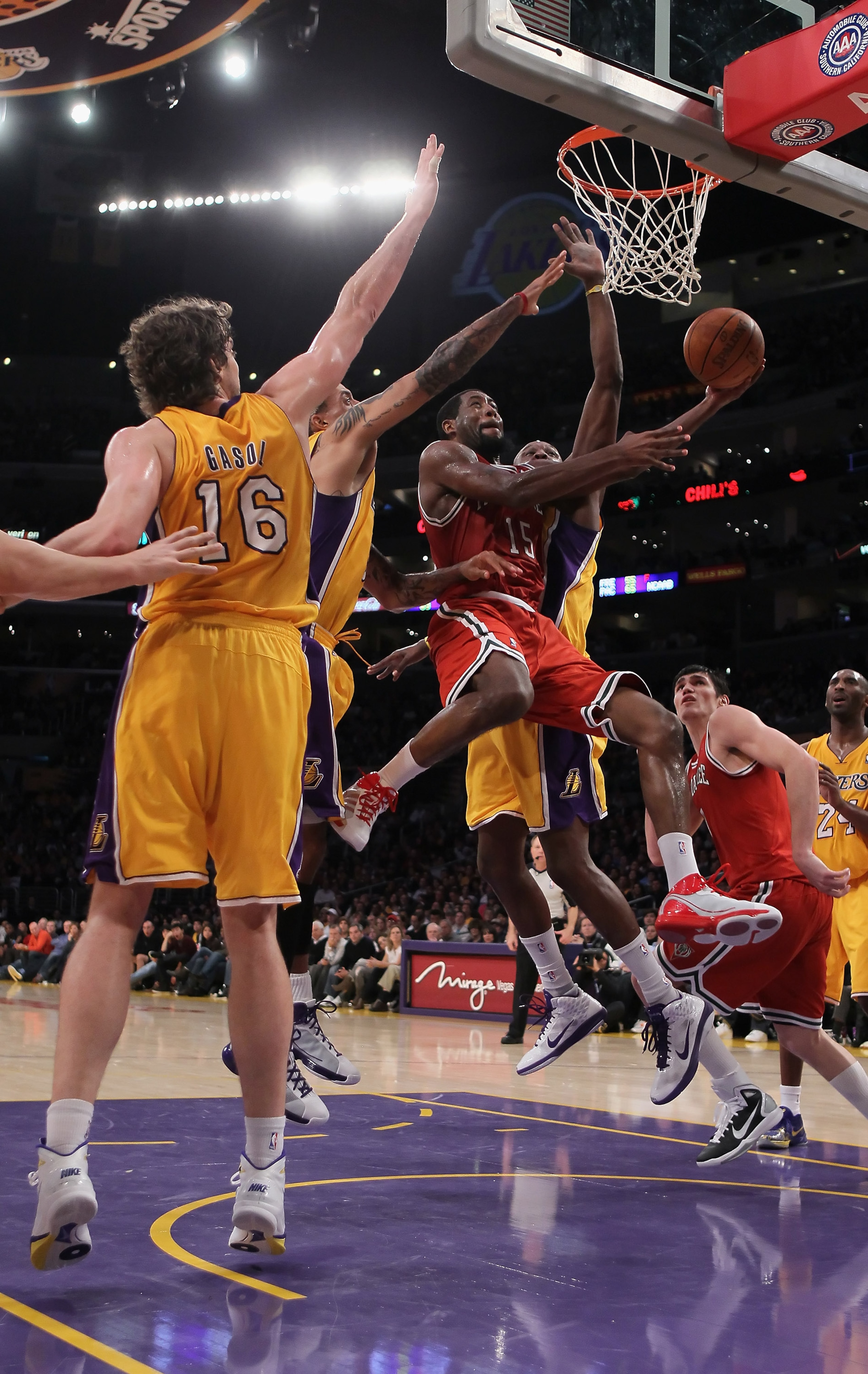 LOS ANGELES, CA - DECEMBER 21:  John Salmons #15 of the Milwaukee Bucks drives past Pau Gasol (L) #16 and Lamar Odom (R) #7 of the Los Angeles Lakers during the second half at Staples Center on December 21, 2010 in Los Angeles, California. The Bucks defea
