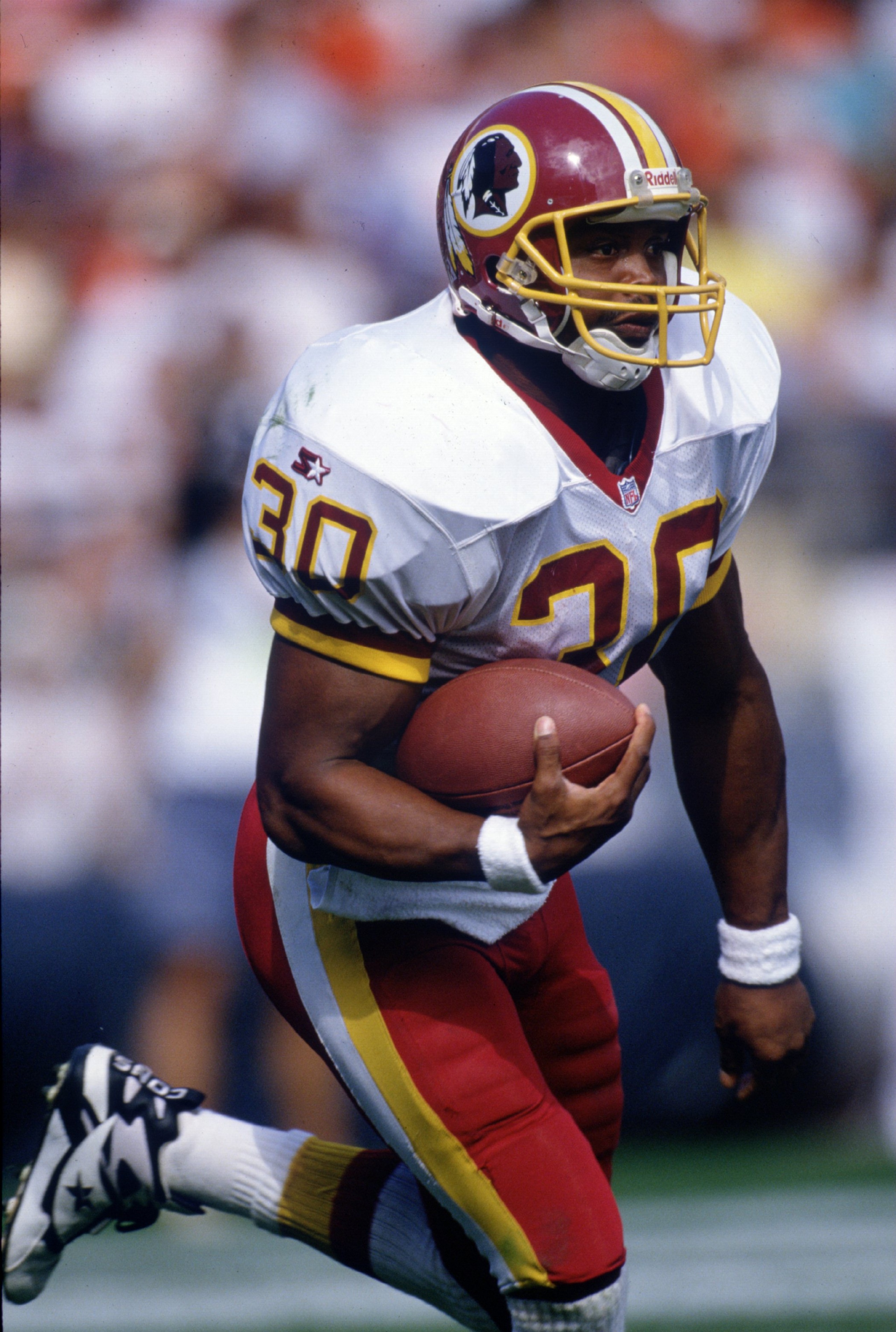 17 Sep 1995: Running back Brian Mitchell of the Washington Redskins keeps his focused up field as he runs with the ball during a carry in the Redskins 38-31 loss to the Denver Broncos at Mile High Stadium in Denver, Colorado.