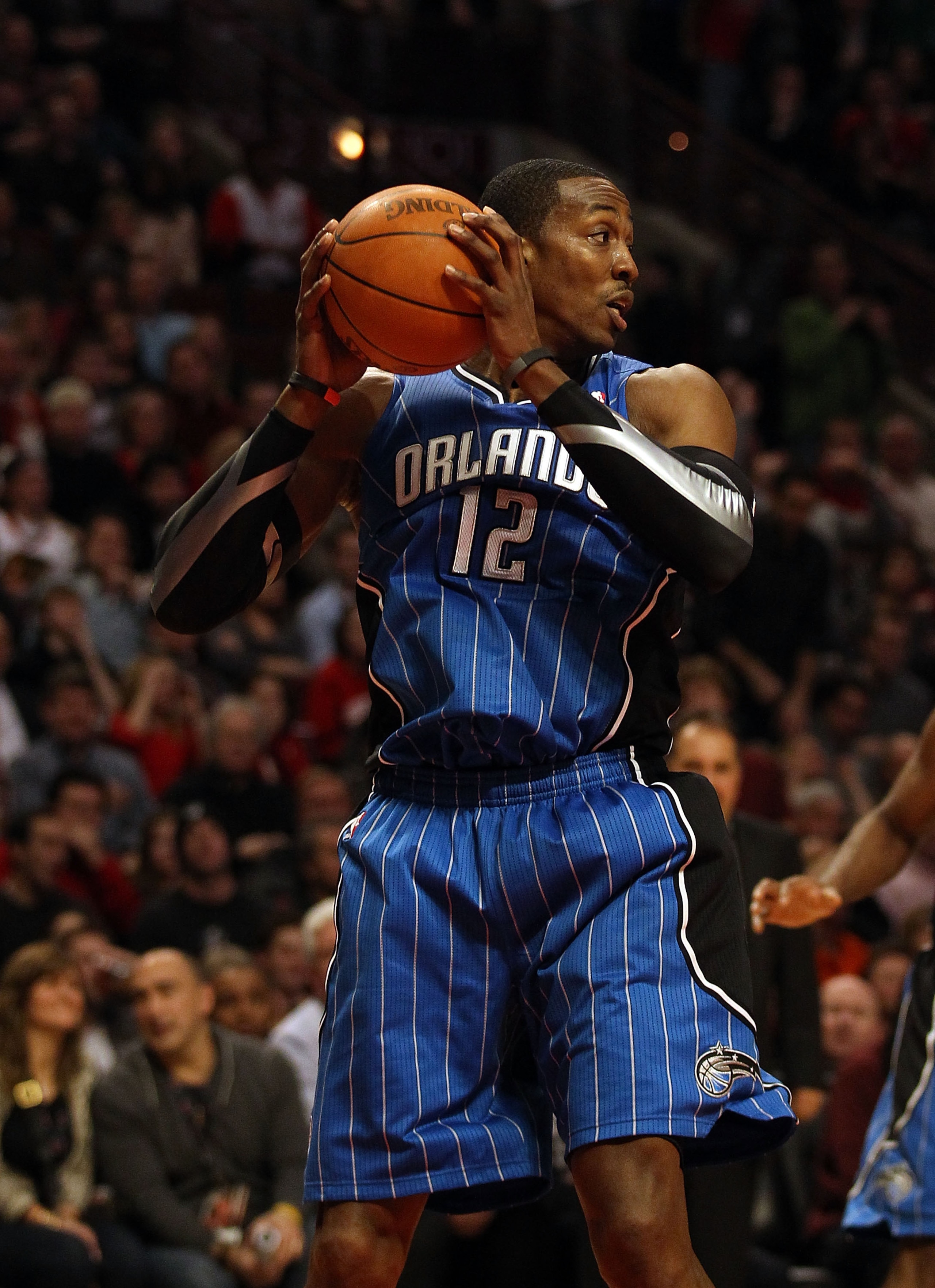 CHICAGO, IL - JANUARY 28: Dwight Howard #12 of the Orlando Magic grabs a rebound against the Chicago Bulls at the United Center on January 28, 2011 in Chicago, Illinois. The Bulls defeated the Magic 99-90. NOTE TO USER: User expressly acknowledges and agr CHICAGO, IL - JANUARY 28: Dwight Howard #12 of the Orlando Magic grabs a rebound against the Chicago Bulls at the United Center on January 28, 2011 in Chicago, Illinois. The Bulls defeated the Magic 99-90. NOTE TO USER: User expressly acknowledges and agr