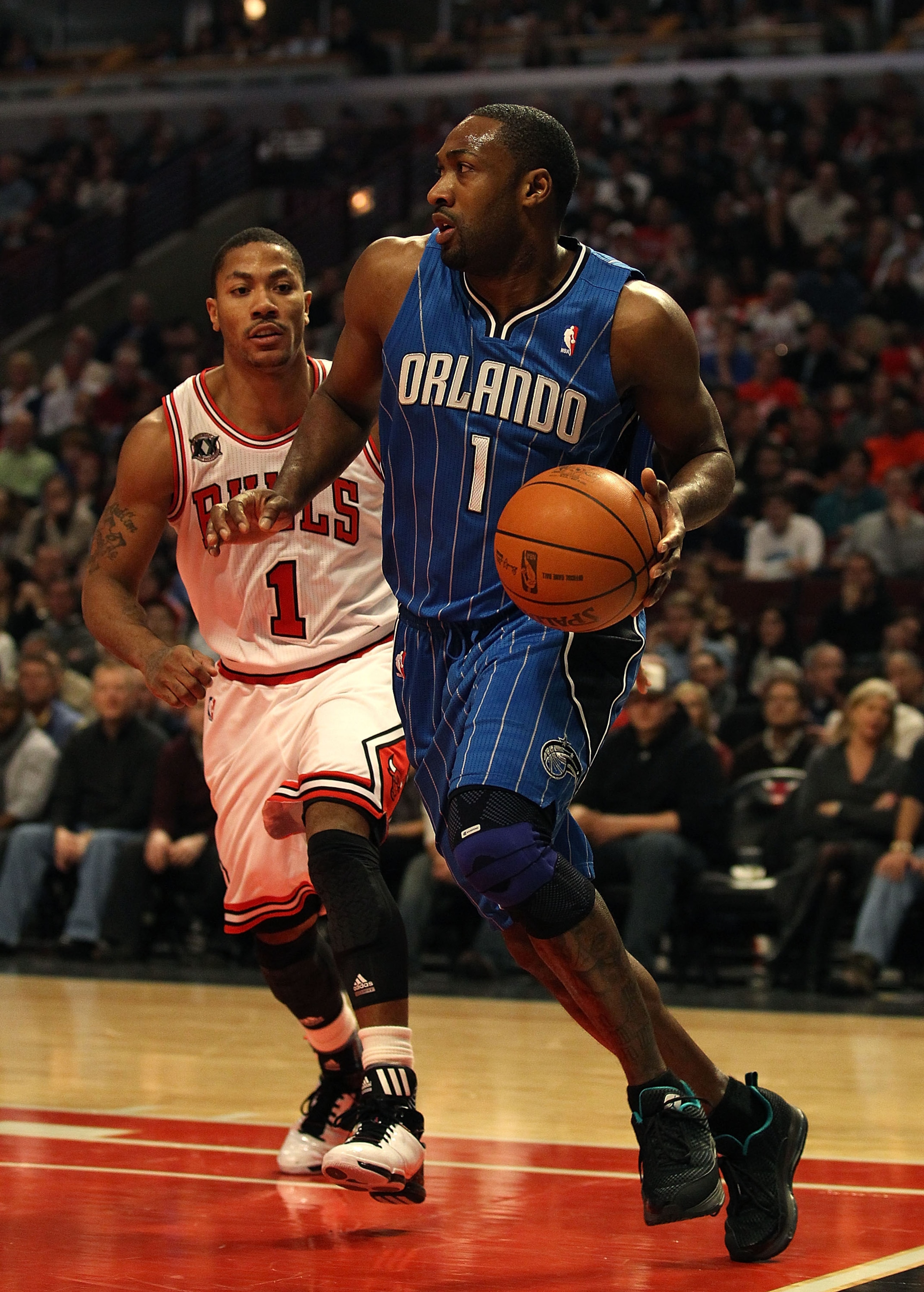 CHICAGO, IL - JANUARY 28: Gilbert Arenas #1 of the Orlando Magic moves past Derrick Rose #1 of the Chicago Bulls at the United Center on January 28, 2011 in Chicago, Illinois. The Bulls defeated the Magic 99-90. NOTE TO USER: User expressly acknowledges a CHICAGO, IL - JANUARY 28: Gilbert Arenas #1 of the Orlando Magic moves past Derrick Rose #1 of the Chicago Bulls at the United Center on January 28, 2011 in Chicago, Illinois. The Bulls defeated the Magic 99-90. NOTE TO USER: User expressly acknowledges a