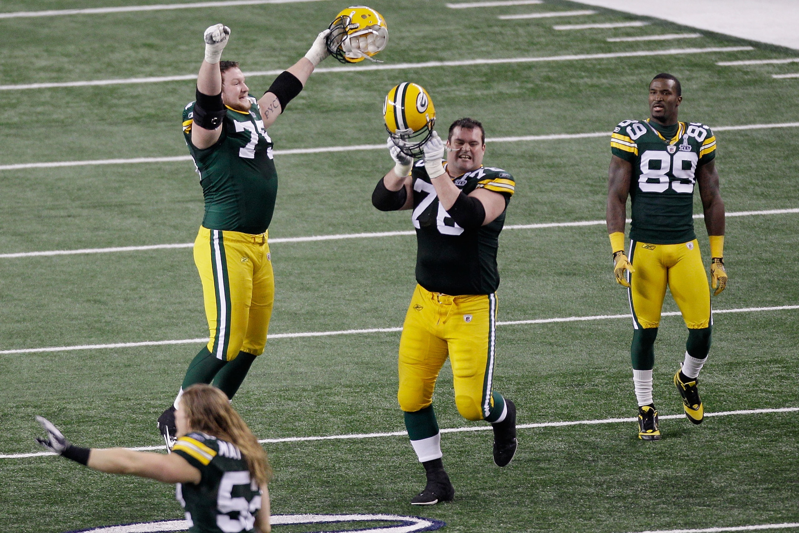 ARLINGTON, TX - FEBRUARY 06:  Bryan Bulaga #75 Chad Clifton #76, and James Jones #89 of the Green Bay Packers celebrate defeating the Pittsburgh Steelers 31 to 25 in Super Bowl XLV at Cowboys Stadium on February 6, 2011 in Arlington, Texas.  (Photo by Rob