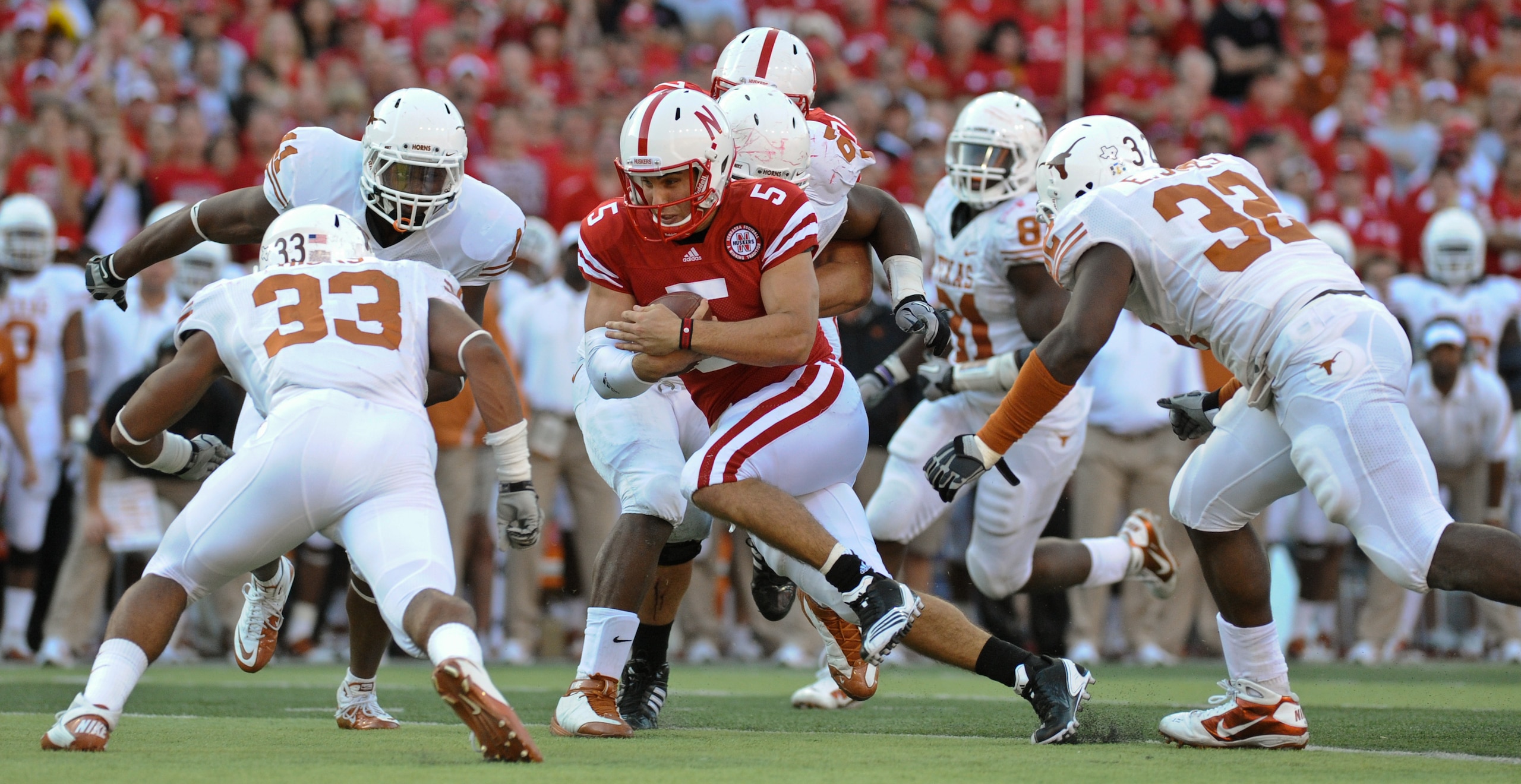 LINCOLN, NE - OCTOBER 16: Quarterback Zac Lee #5 of the Nebraska Cornhuskers runs through linebacker Jordan Hicks #33 and defensive end Eddie Jones #32 of the Texas Longhorns during second half action of their game at Memorial Stadium on October 16, 2010 
