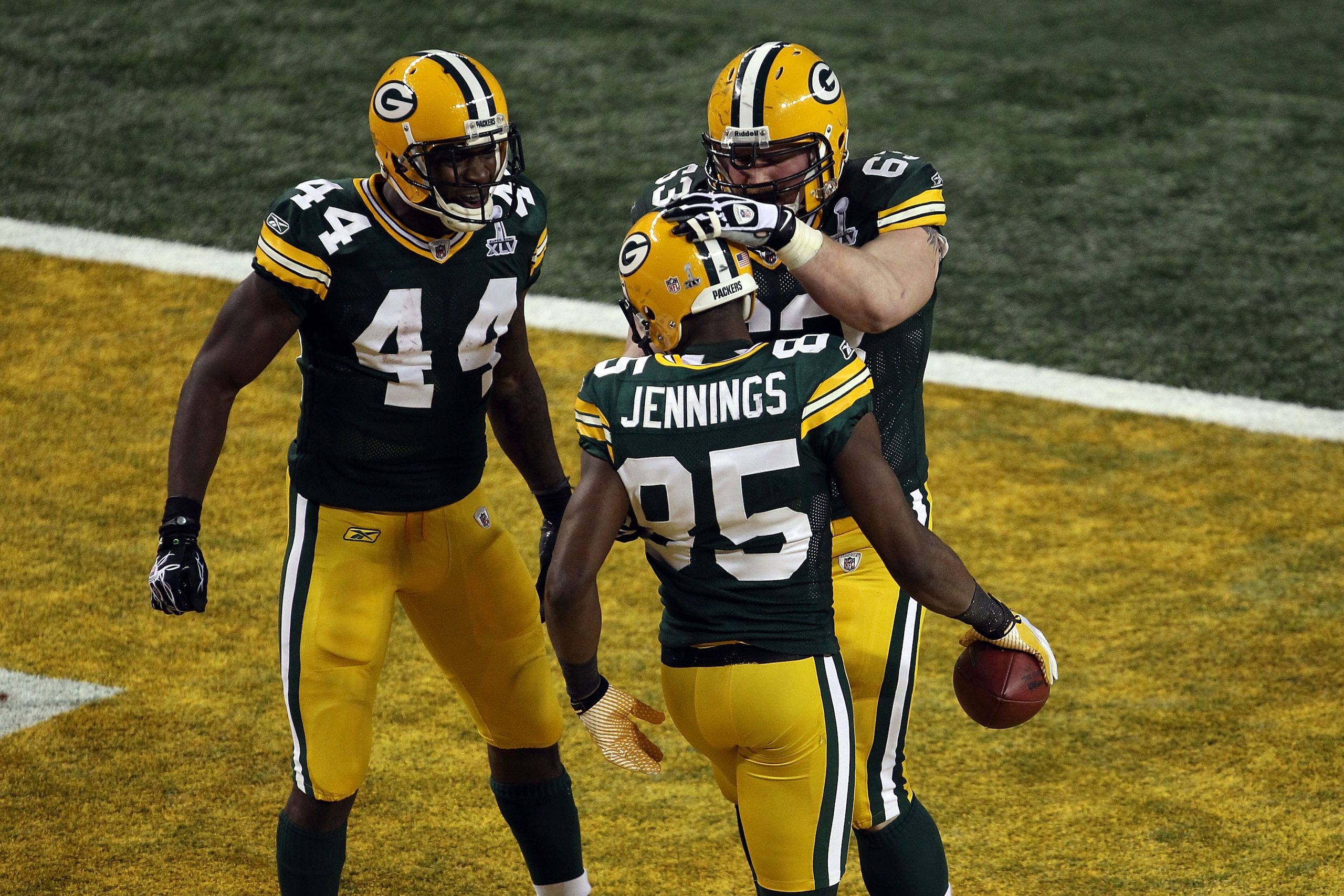 ARLINGTON, TX - FEBRUARY 06:  Greg Jennings #85 celebrates with teammates Scott Wells #63 and James Starks #44 of the Green Bay Packers after catching a 21 yard touchdown pass against the Pittsburgh Steelers during the second quarter of Super Bowl XLV at