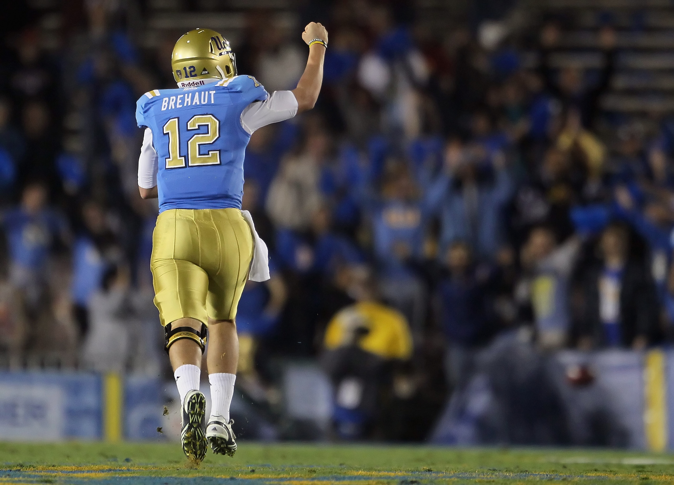 PASADENA, CA - DECEMBER 04:  Quarterback Richard Brehaut #12 of the UCLA Bruins celebrates Johnathan Franklin's (not pictured) touchdown in the first half against the USC Trojans at the Rose Bowl on December 4, 2010 in Pasadena, California.  (Photo by Jef